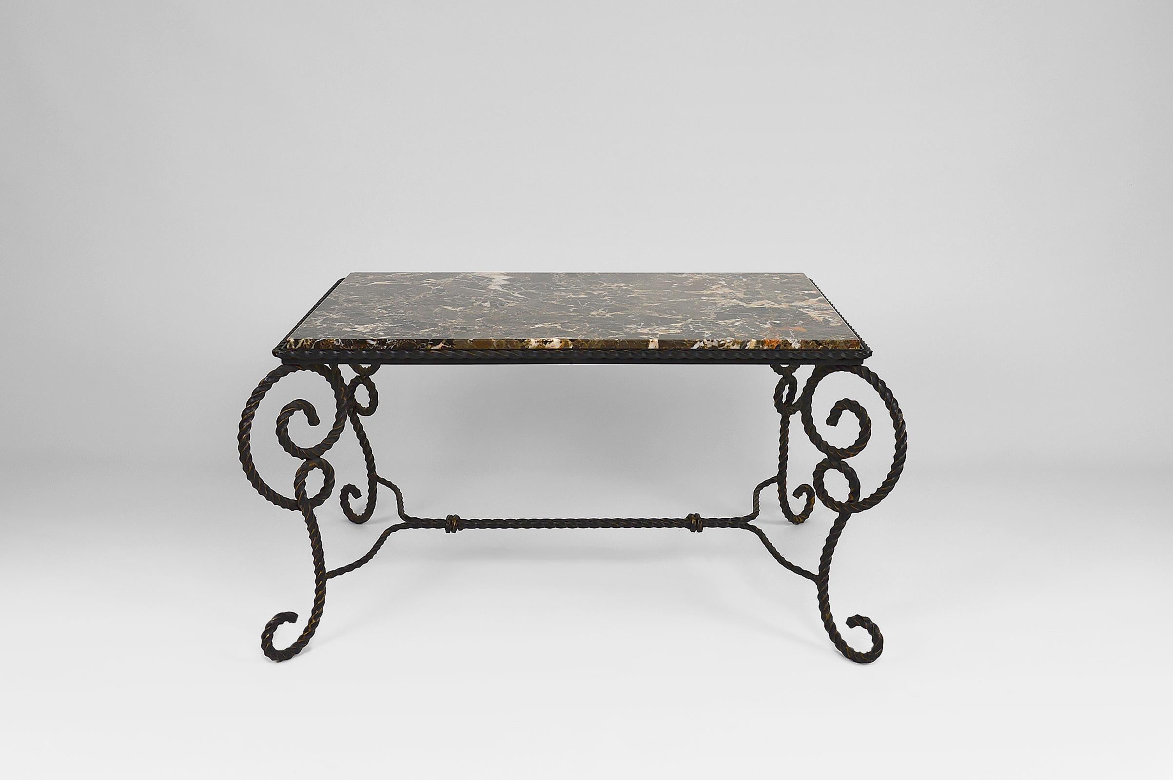 Elegant rectangular coffee / side table made of a very beautiful brown / taupe colored marble and a twisted wrought iron base imitating ropes. 
Beautiful black and golden brown patina.

Art Deco, France, circa 1940-1950.

Nice build