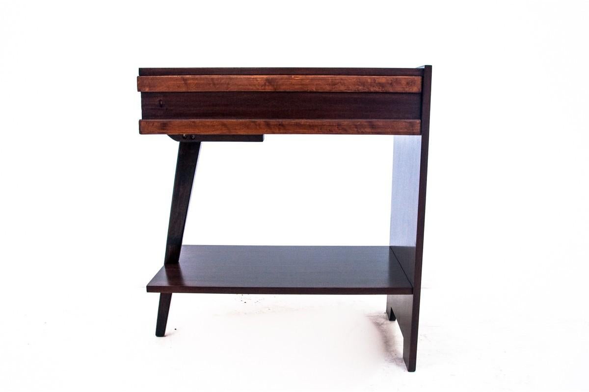 Art Deco side table made in Poland in the 1950s.

The table has an unusual, modern shape that will perfectly complement contemporary interiors. Table with one spacious drawer.

Very good condition, after renovation. The wood has been cleaned and