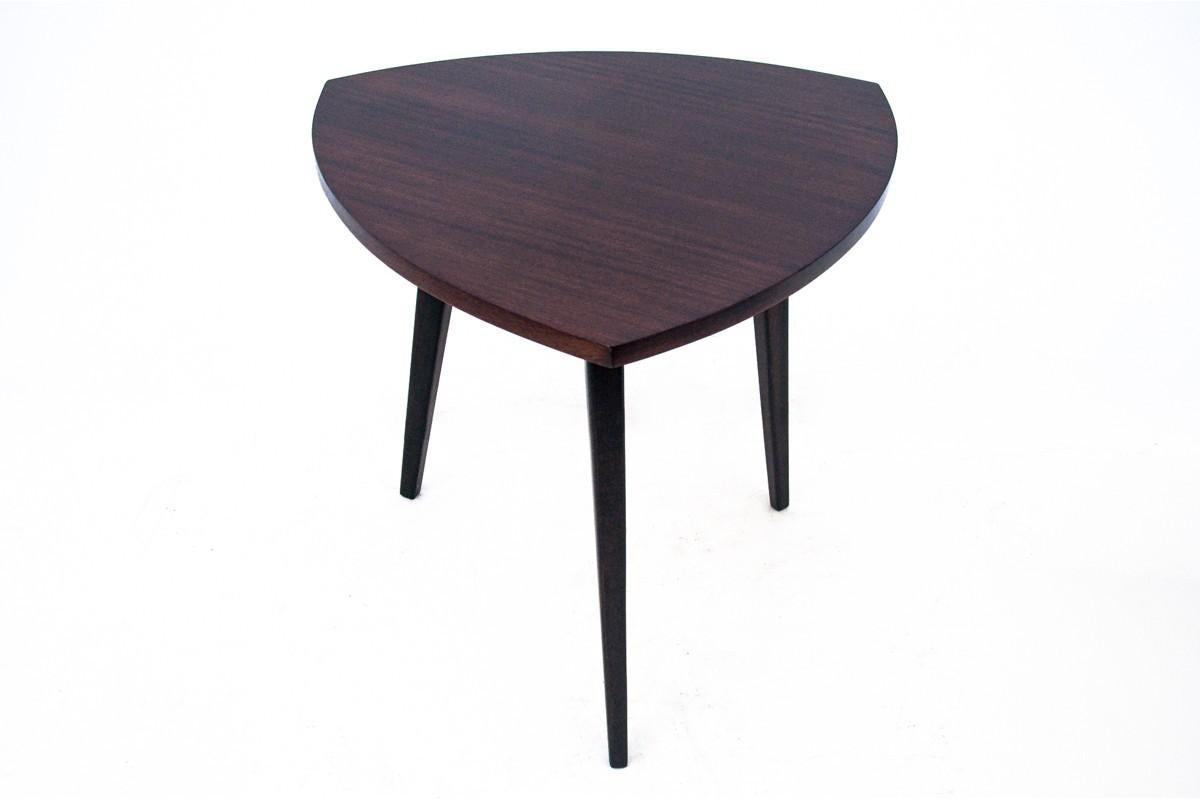 Art Deco side table made in Poland in the 1950s.

A triangular table with rounded sides, a top veneered with rosewood with beautiful grain. The minimalist, very modern form will work perfectly in contemporary interiors.

Very good condition, after