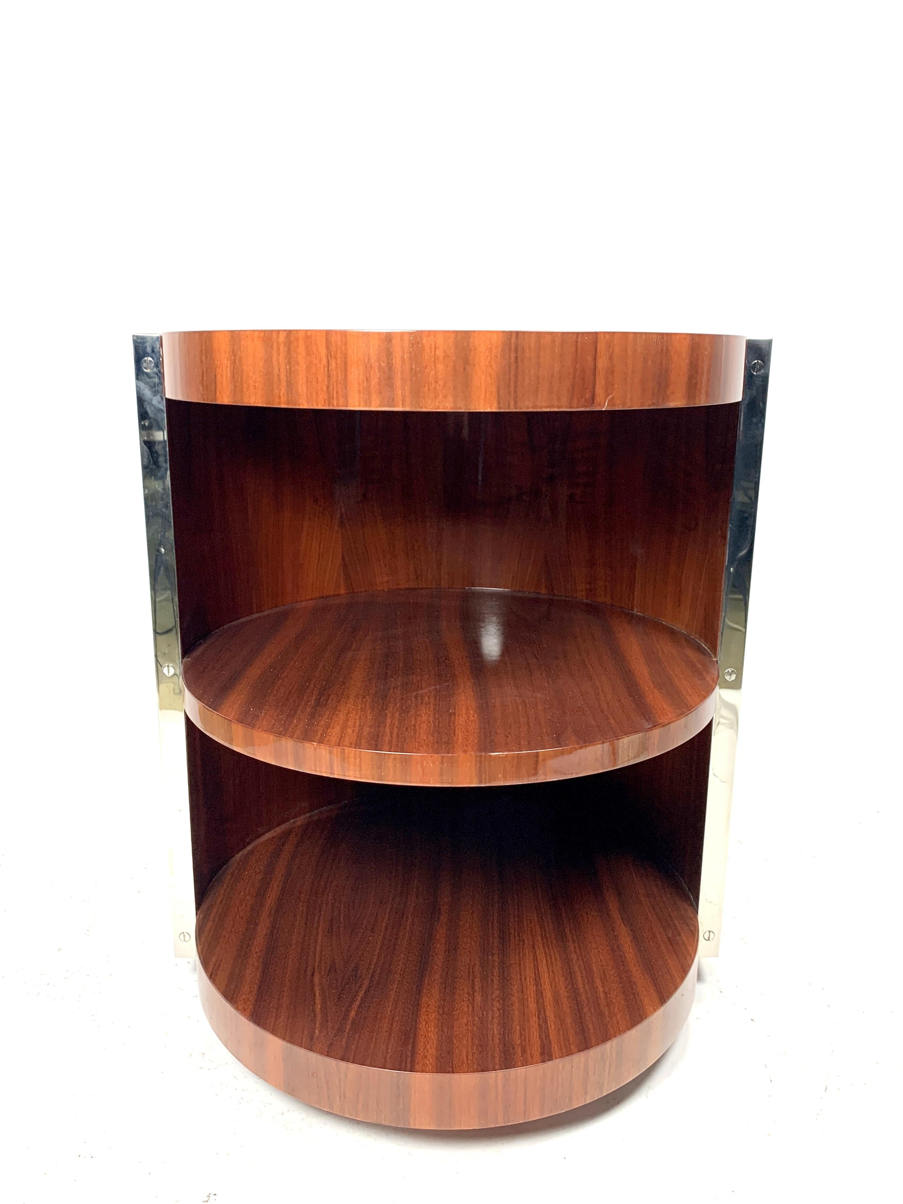 This Art Deco style side table features a high gloss finish of walnut veneer and chrome-plated steel on the edges. It's in great condition with sliders on the base. Very sturdy, massive piece.