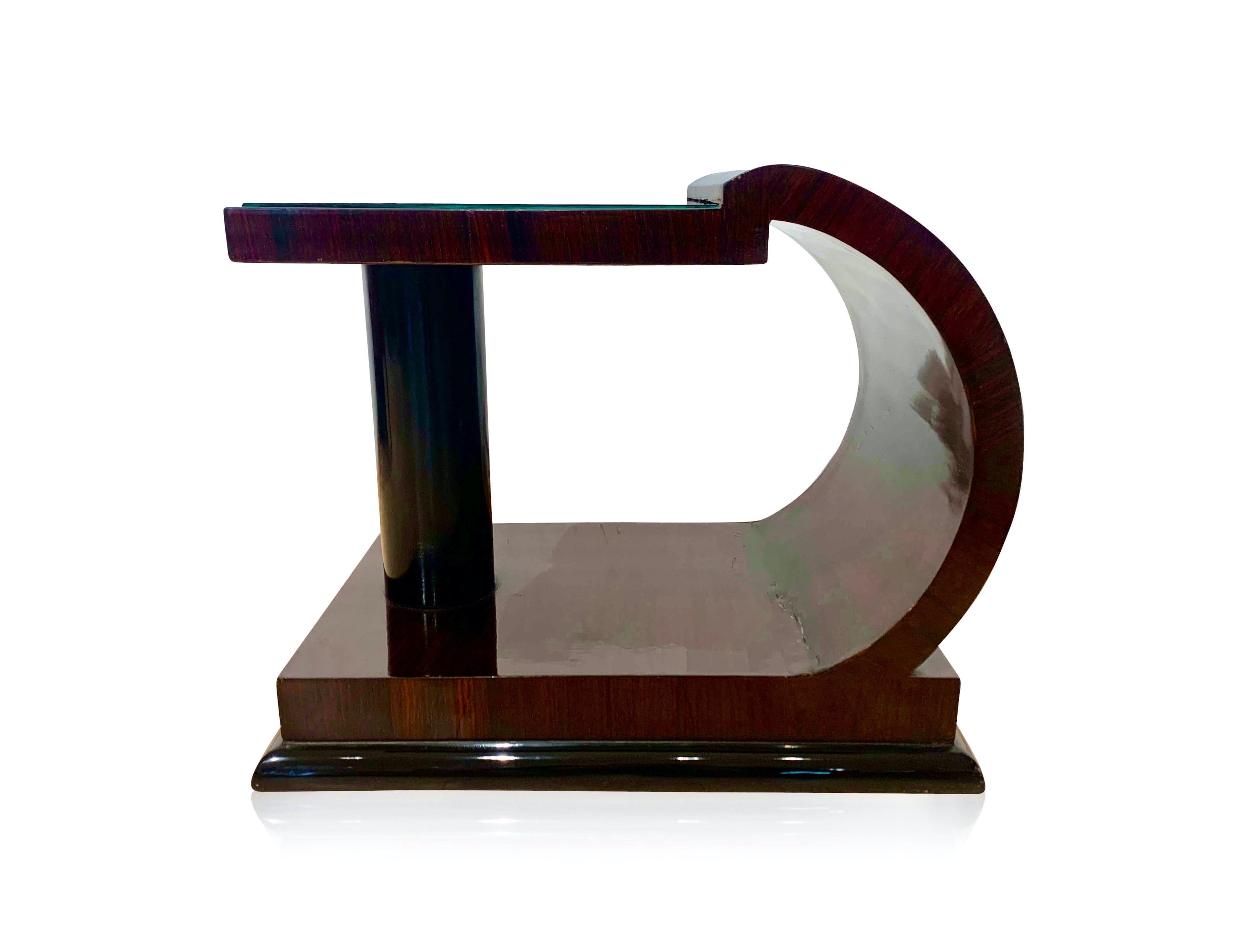 Art Deco side / sofa / end table from France, circa 1930.

Lovely elegant design with rounding one side and column on the other.
Rosewood / Palisander veneer on softwood and shellac hand-polished (French polish). Ebonized column and base. Above