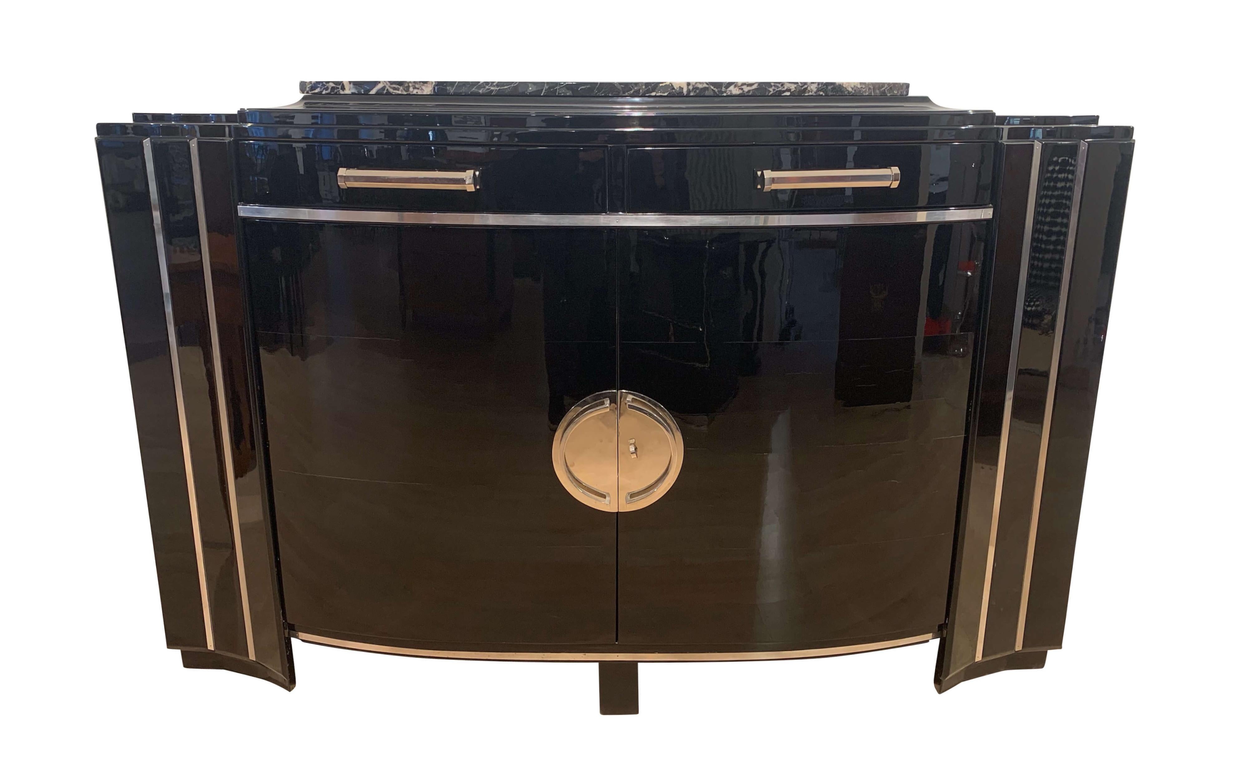 Elegant Art Deco sideboard with curved / convex doors, black lacquer, mahogany and chromed parts, from France, circa 1930.

Walnut solid wood corpus elaborately lacquered with black lacquer and high-gloss polished.
Originally is had a dark stained