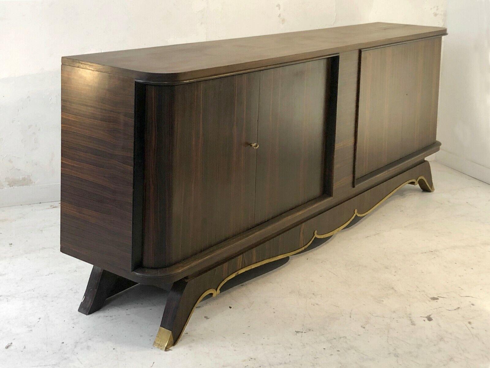 A sumptuous Art Déco sideboard, neoclassical, made in solid oak plated in Macassar ebony veneer on the outside, of Sycamore inside the doors, finished with elegant bronze elements, attributed to Jules Leleu, France 1930-1940.

This beautiful