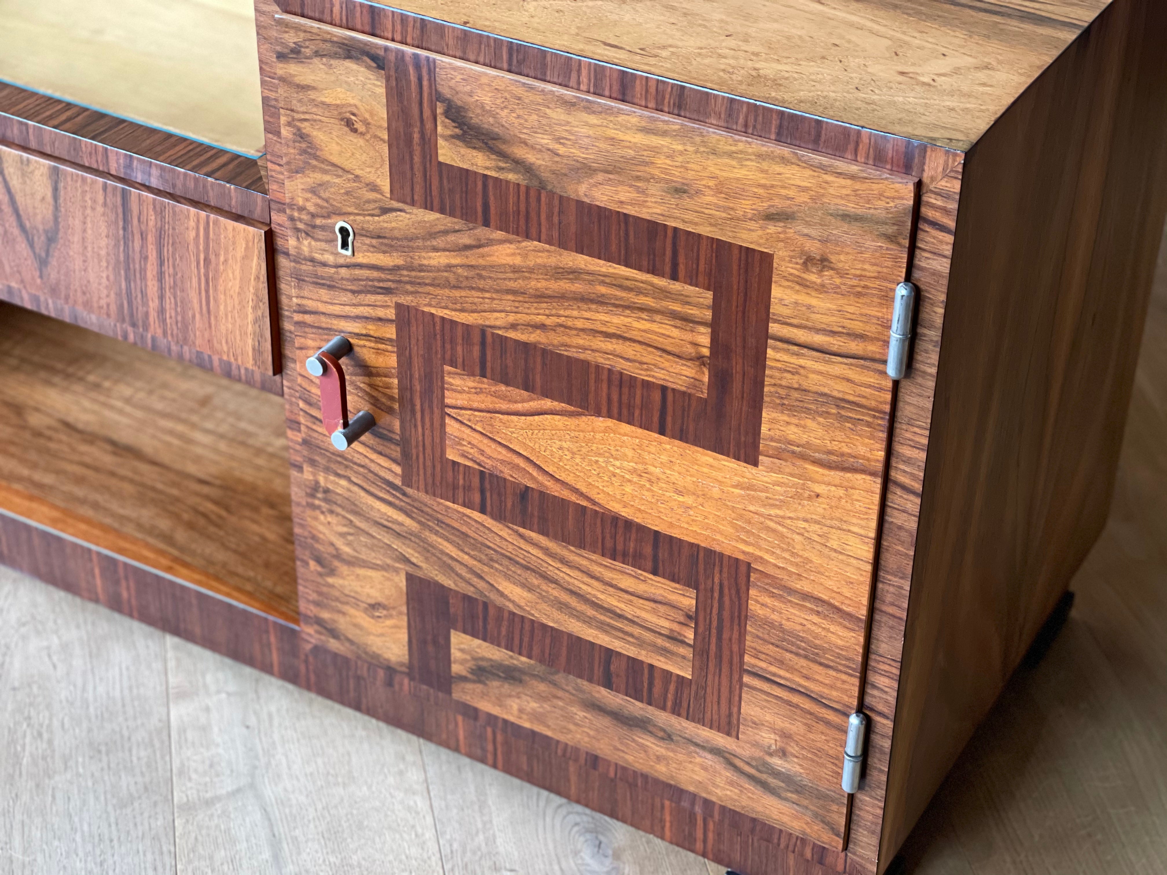 Art Deco Sideboard manufactured by the prestigious furniture factory of Lingel Karoly and Sons in the year 1930. Walnut veneer with beautiful geometrical inlay on doorfront. Inside the door manufacture stamp mark as part of the authenticity.