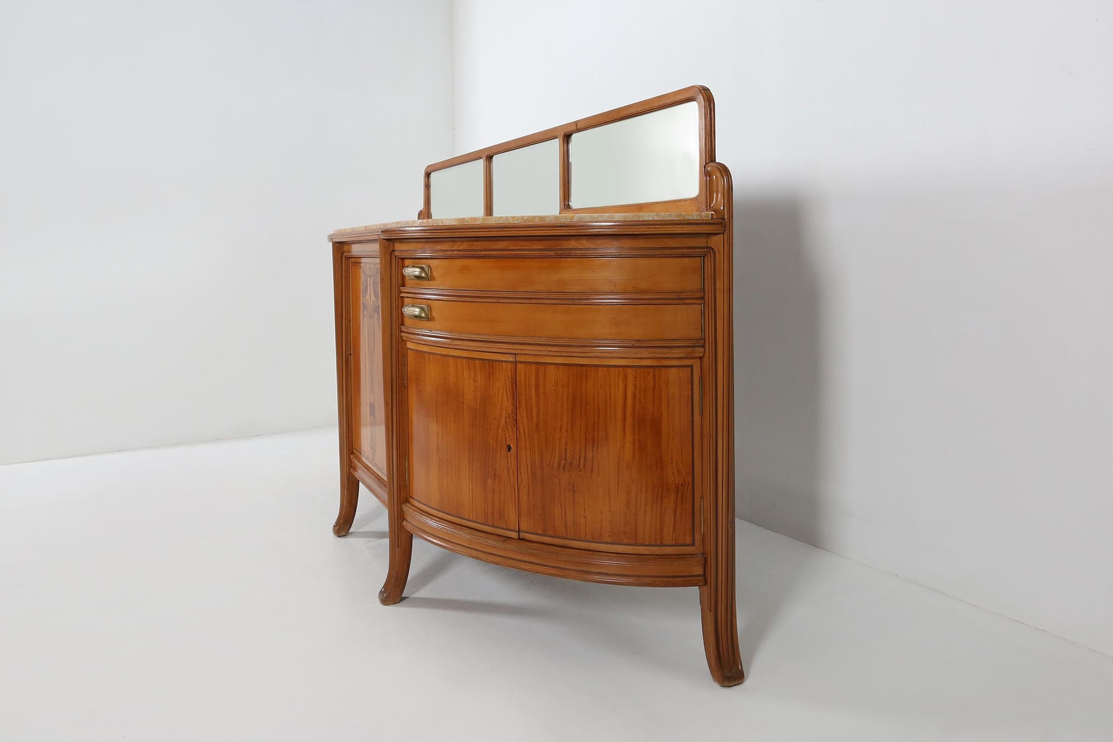 Art Deco sideboard by French designer Maurice Dufrène.
Made of massif walnut wood and a beige marble top.
beautiful inlay wood in the front door and moon-shaped drawers with bronze handles.

This cabinet was exhibited at the 