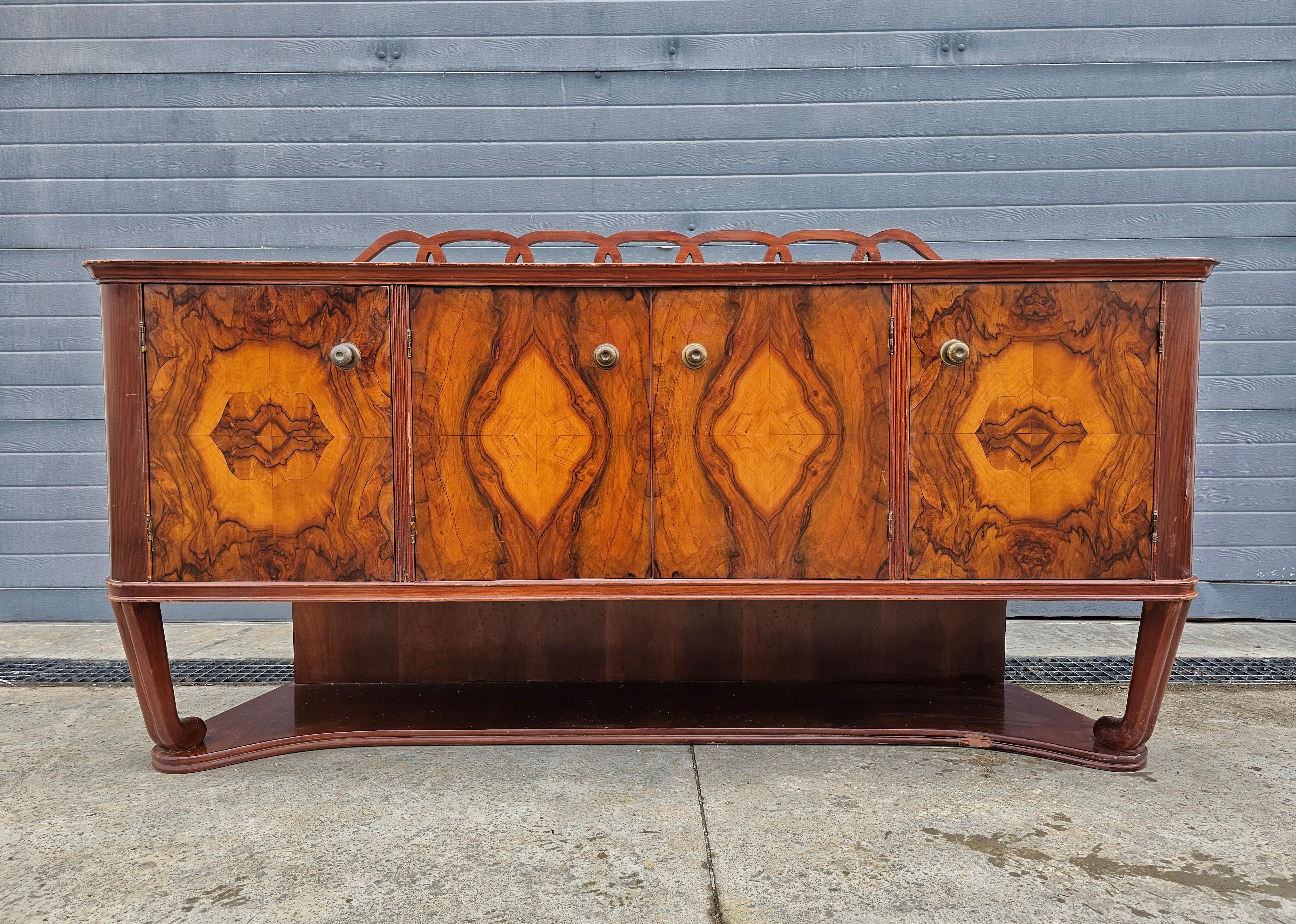 En este anuncio encontrarás un magnífico aparador Art Déco realizado en nogal, con una impresionante chapa de nogal burl. Cuenta con 4 puertas tras las que se encuentran 3 armarios. Los herrajes originales de latón dan al aparador un aspecto muy