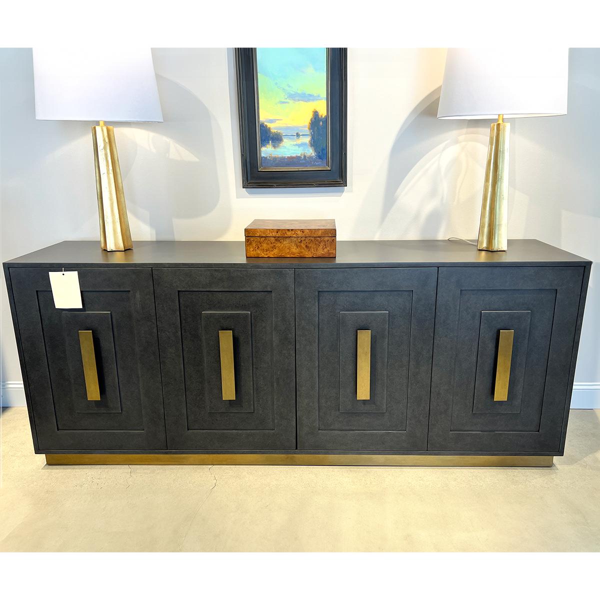 A perfect blend of elegance and functionality. This exquisite piece features a smooth top, ideal for showcasing your favorite decor. 

The door fronts are adorned with raised panel details, adding a touch of sophistication. The smooth brass pulls