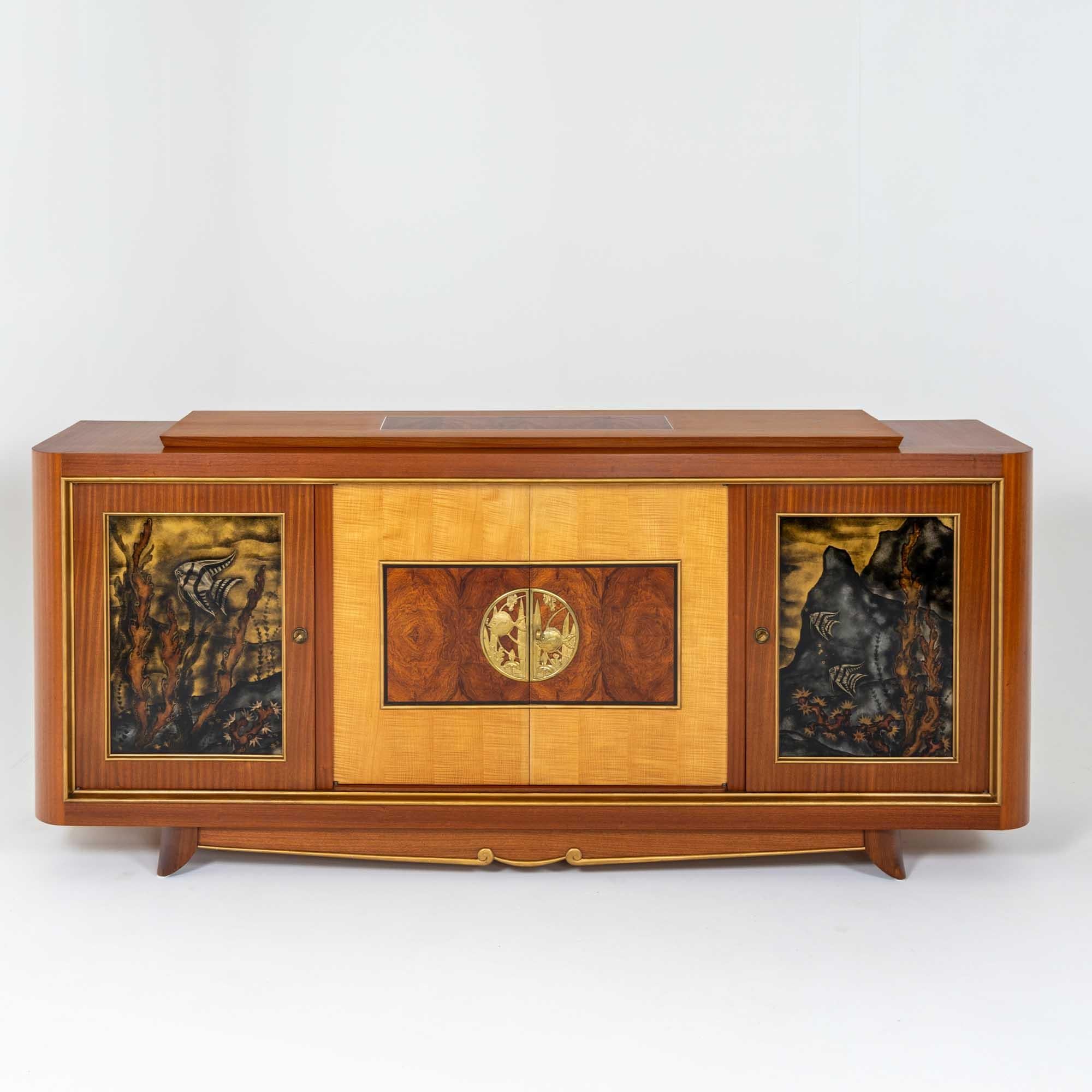 Large high quality sideboard of the French Art Deco. The sideboard stands on an elegantly executed plinth zone with brass moulding. Above it rises the four-door corpus with framing brass profiles and a contrasting veneer pattern in maple and burl.