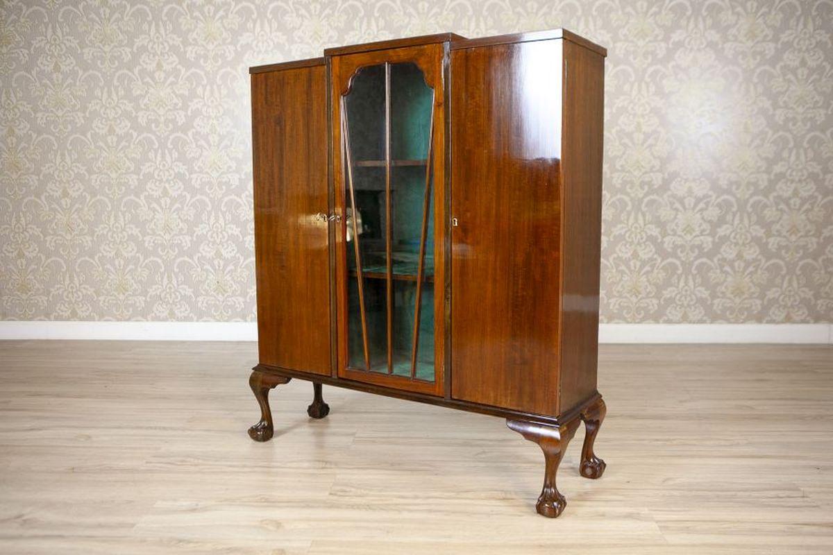 Art Deco Sideboard From the 1st Half of the 20th Century

A small, three-door sideboard supported by curved legs ending in bird claw-and-ball feet. The central section is lined with fabric and features glass doors with radiating muntins. Each