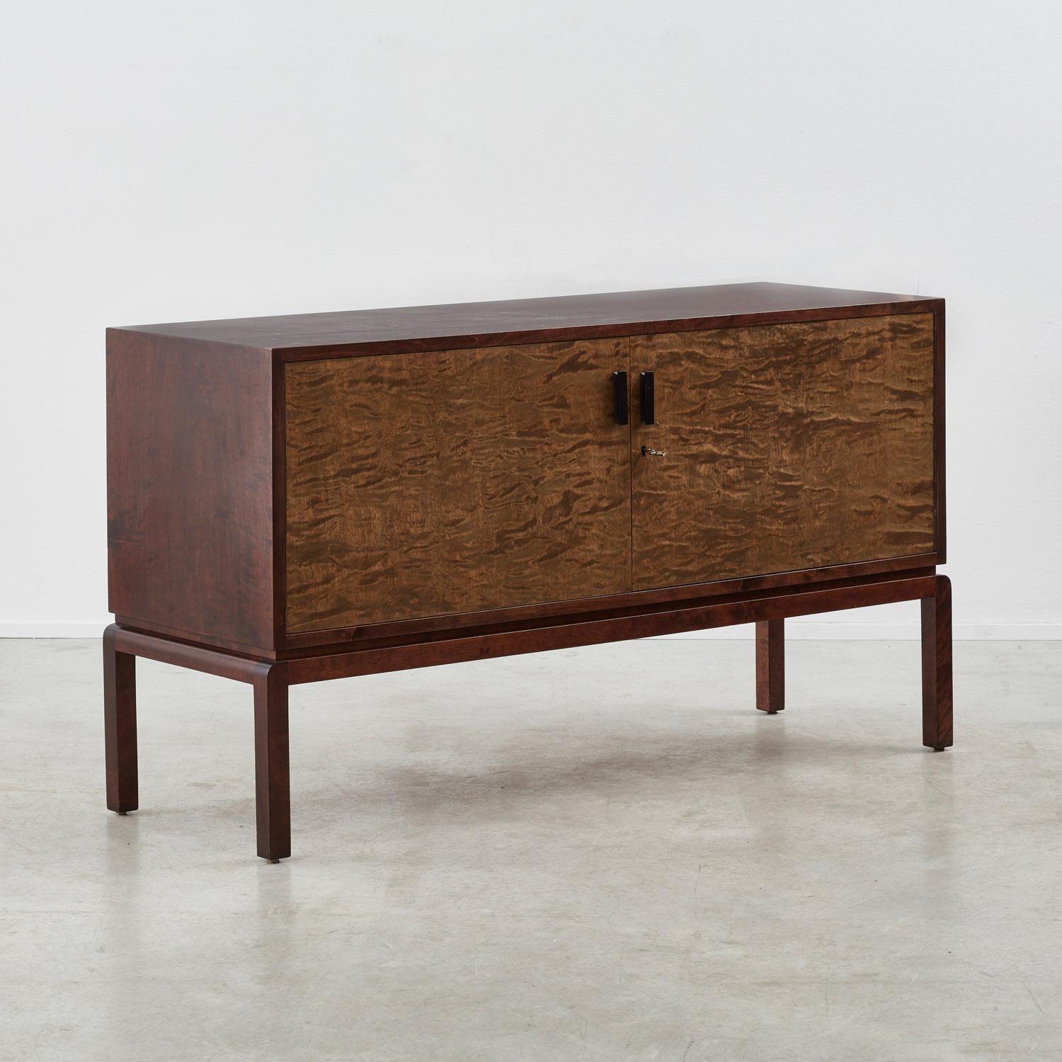 This striking sideboard is typical of the Swedish Grace movement, a lesser-known Scandinavian branch of Art Deco that beautified geometric silhouettes with simple decorative flourishes. Two handles reveal wide cupboards, while appealing joinery