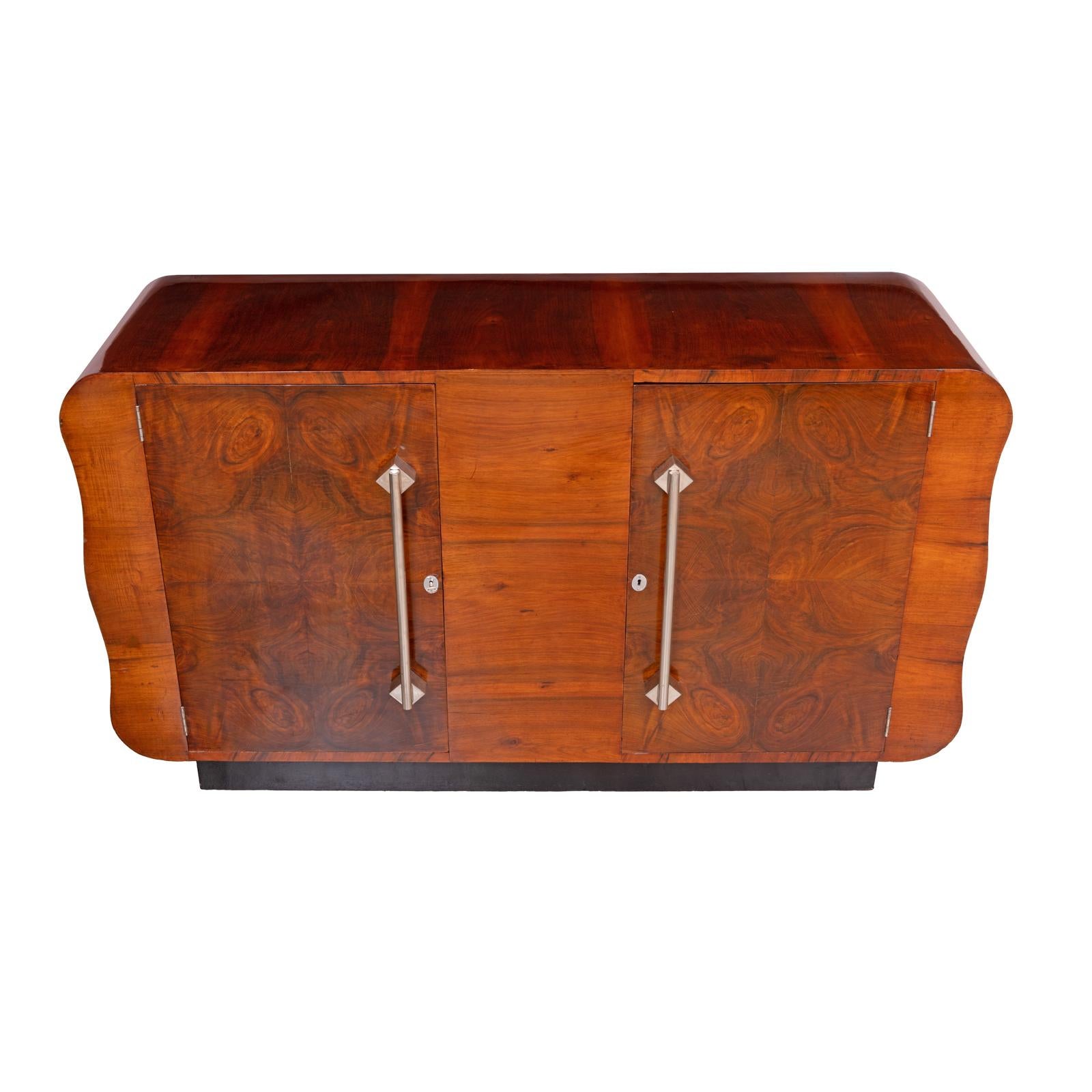 Art Deco Sideboard in Walnut Burl with Chrome Handles, circa 1930s

Origin: Europe, circa 1930s
Style: Art Deco
Materials: Walnut burl veneer, chrome-plated metal
Dimensions: Height 91 cm (35.8 in); Width 161 cm (63.4 in); Depth 50 cm (19.7