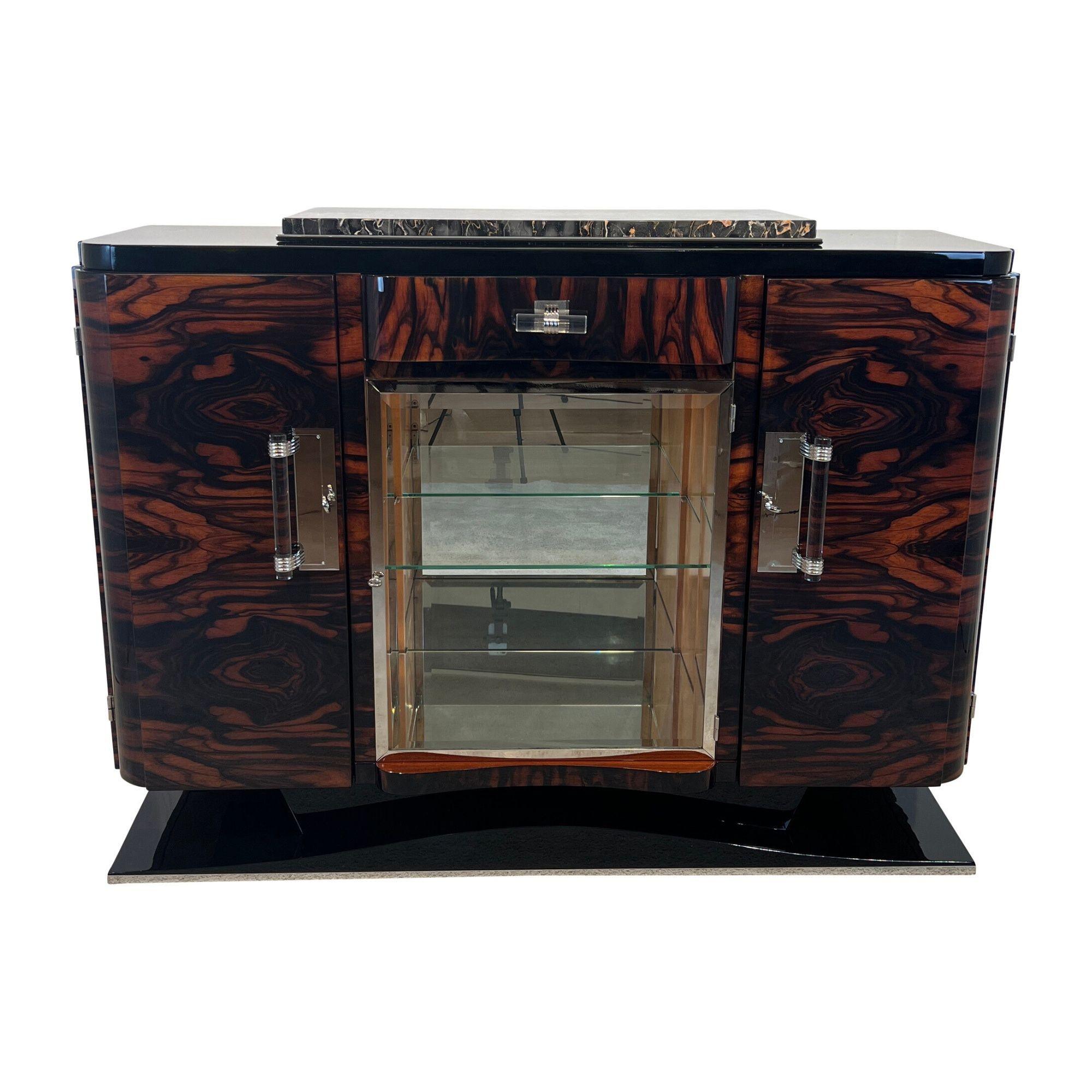 Elegant original french Art Deco Sideboard from around 1930 in excellently restored condition.
Beautiful Macassar ebony cross-veneered and lacquered. Base and cornice lacquered in a perfect high-gloss black.
Lovely original nickel-plated fittings