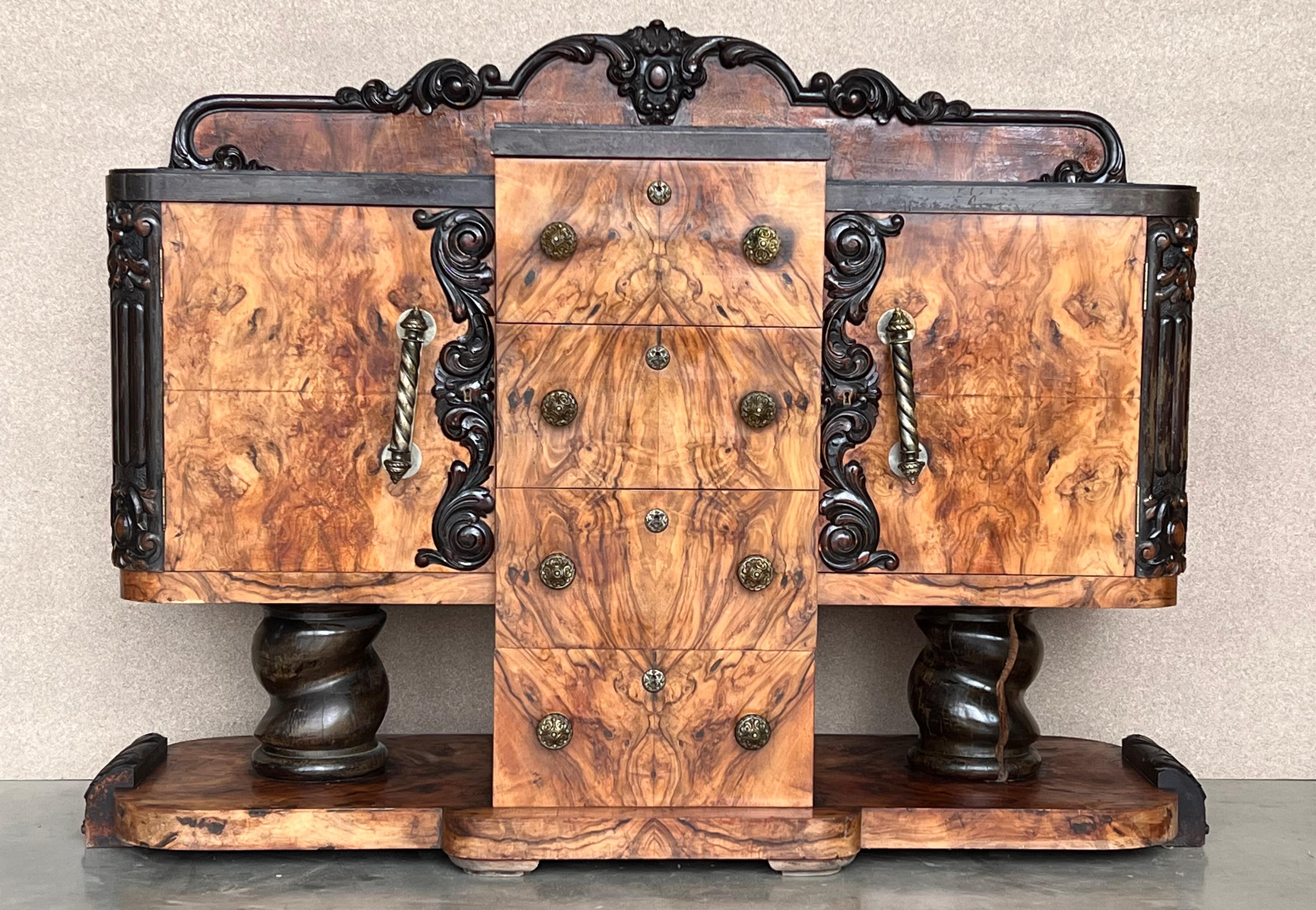 Unique designed Art Deco sideboard or buffet out of Spain from the period circa 1925. This unusual shaped side board impresses with an absolute great book matched burr walnut veneer, giving it a real mesmerizing grain. The exceptional design with