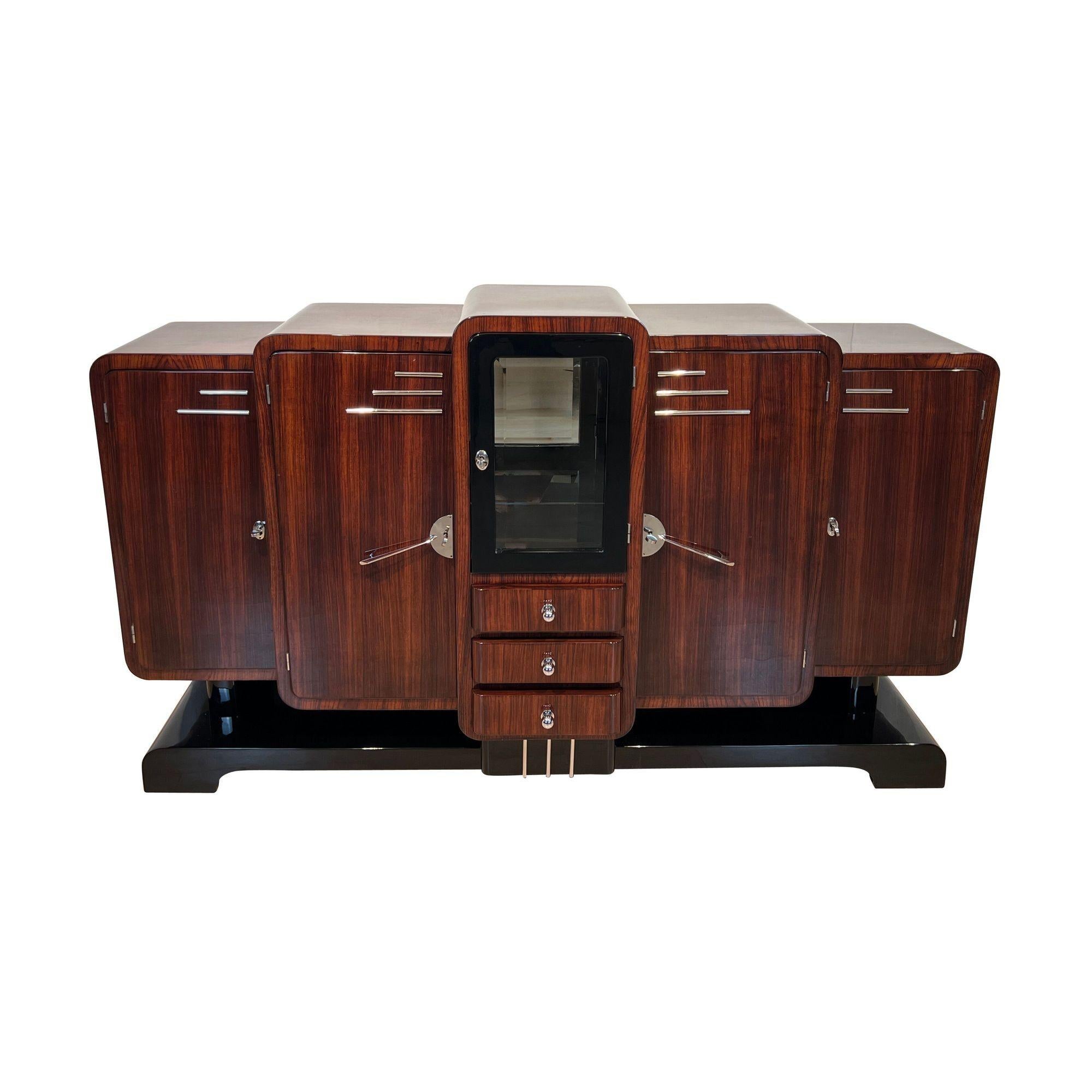 Stunning and very rare, original Art Deco Sideboard or Buffet from France around 1925.
Wonderful Rosewood veneer. Architecturally interesting tiered design, typical for the Art déco period.
Original chrome plated fittings, applications and locks.