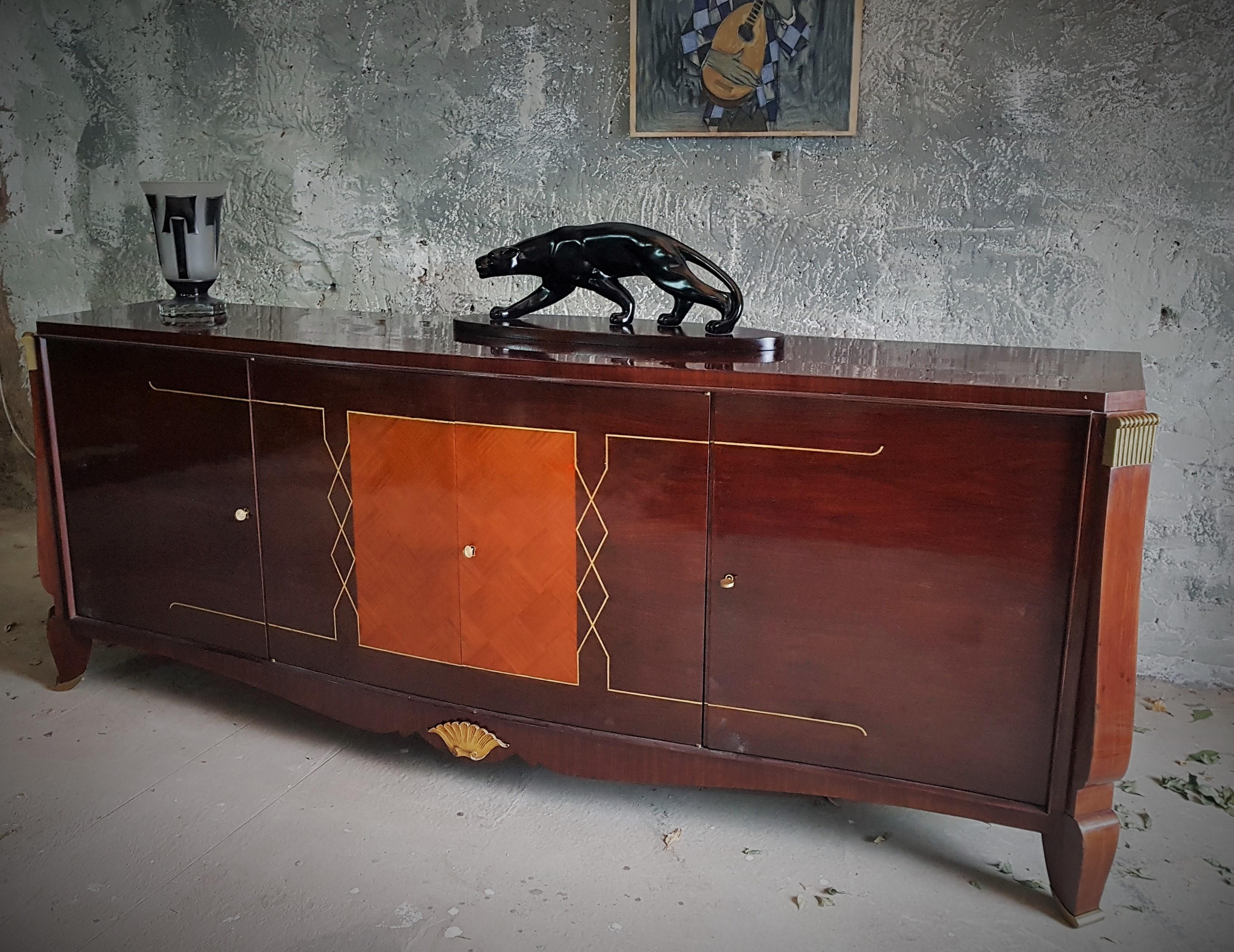 Art Deco sideboard style Maurice Rinck, France 1940.

Typical language of form maison rinck, paris.

Nice mixture of veneers. 
Bronze feet, inlays and details.

Good vintage original condition.