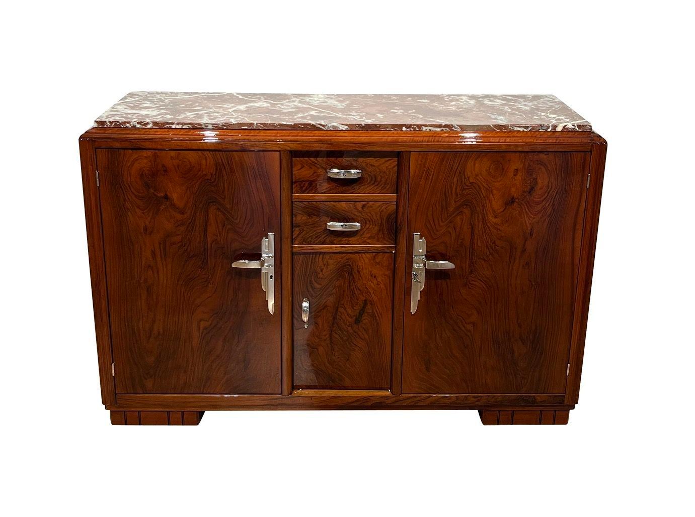 Fully restored original Art Deco Sideboard from France about 1930.
Walnut veneer and solid wood, high-gloss lacquered and polished.
Original bronze fittings, nickel-plated. Original red-white marble top.
Dimensions:
* Metric: H 107 cm x W 160 cm x