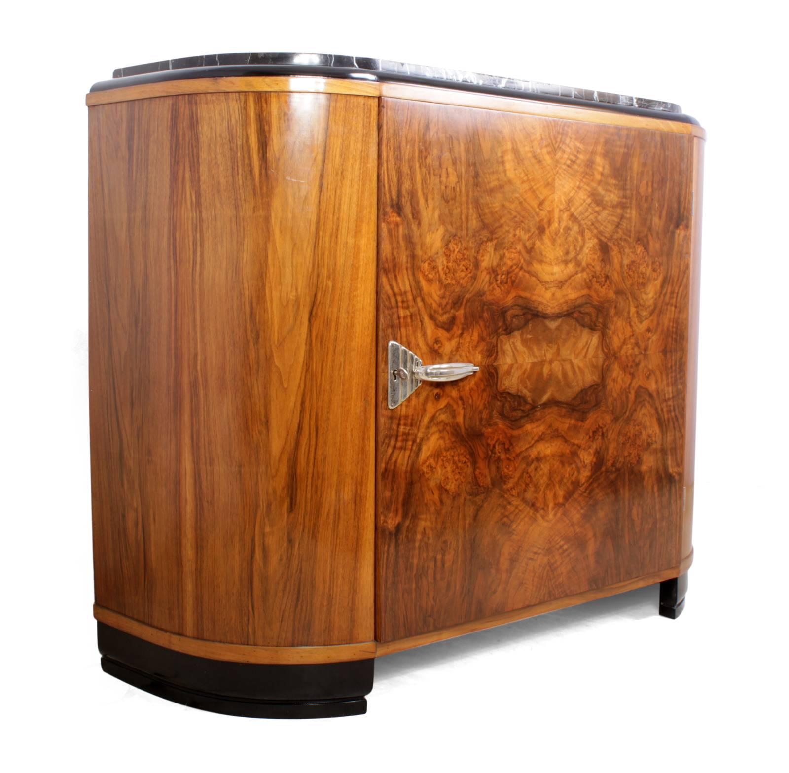 Art Deco sideboard with marble top
A rounded end walnut cabinet produced in France in the 1930s, this has one single door with chromed handle and lock, one key supplied, the marble top is black with white veins and compliments the piece very well,