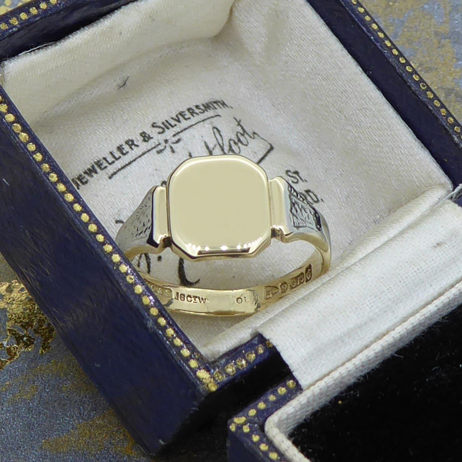 Such an unusual vintage signet ring dating from 1928, having an octagonal plain polished top to flared shoulders and D shaped cross section band.  The shoulders are overlaid with 18ct white gold (not plated) with an engraved pattern.  The top and