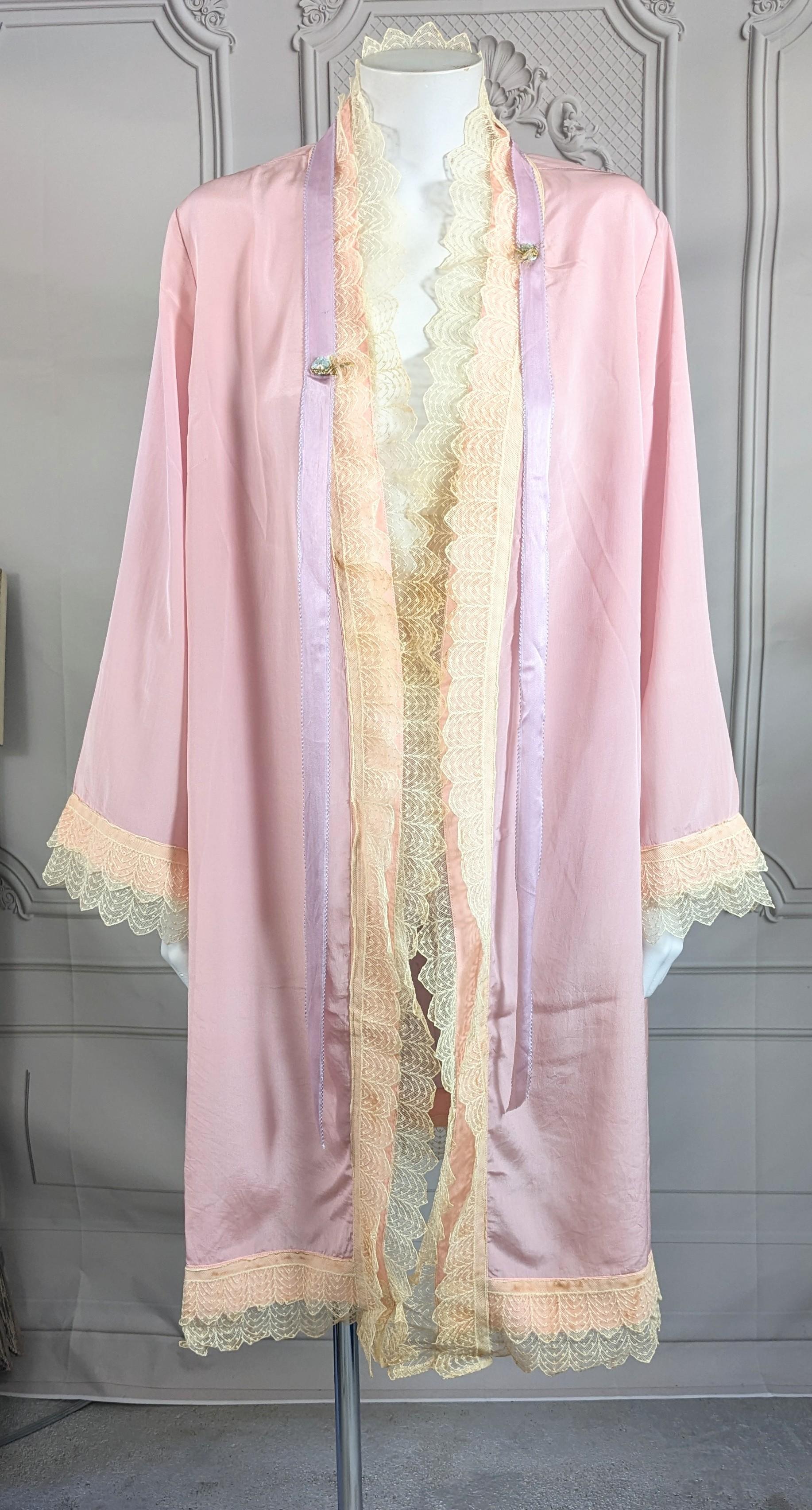 Attractive Pale Shell Pink Deco Silk Crepe Lace Trimmed Robe from the 1920's. Kimono cut with no closures, wide sleeves all edged with 2 layers of Deco cotton lace over peach with purple ombre silk ribbon trim and flower buds. Easy fit Small-
