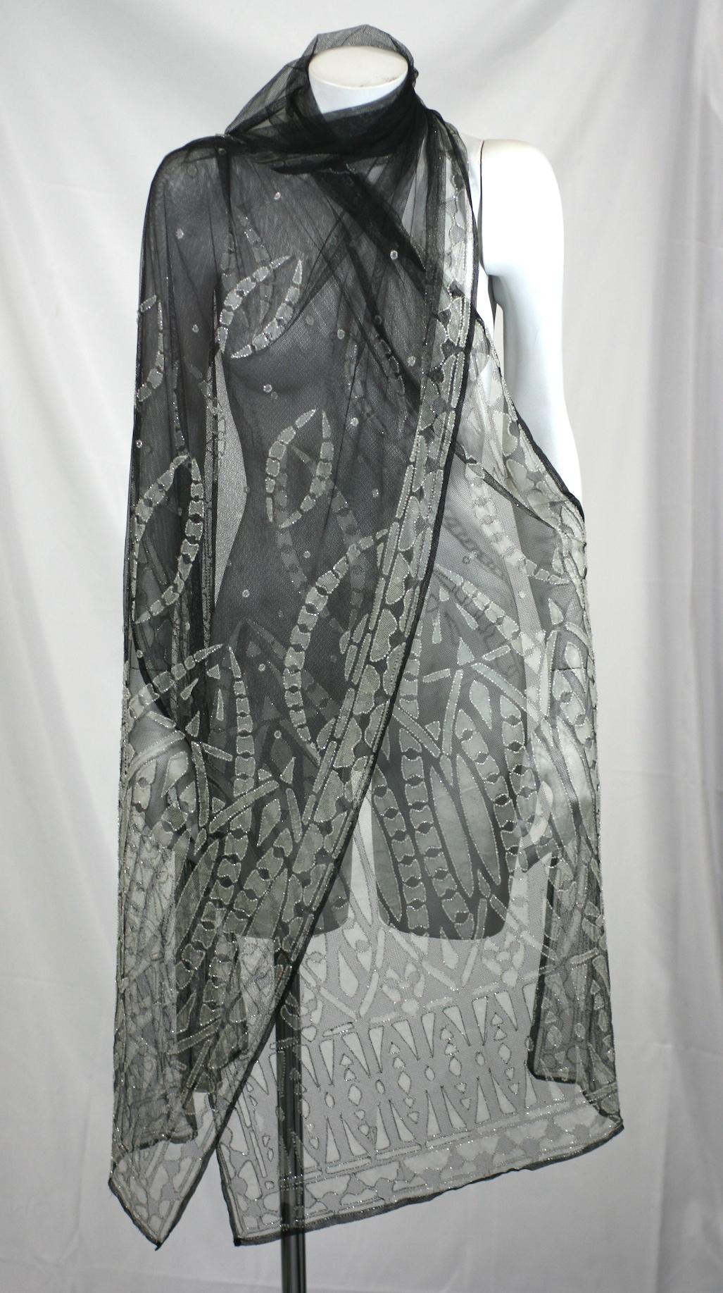 Stunning Art Deco Silk tulle shawl in black and ivory with frosted decorative over beading throughout. Wonderful patterning with black tulle in center and beaded areas predominantly on edges and hems. The ivory patterns are hand outlined in