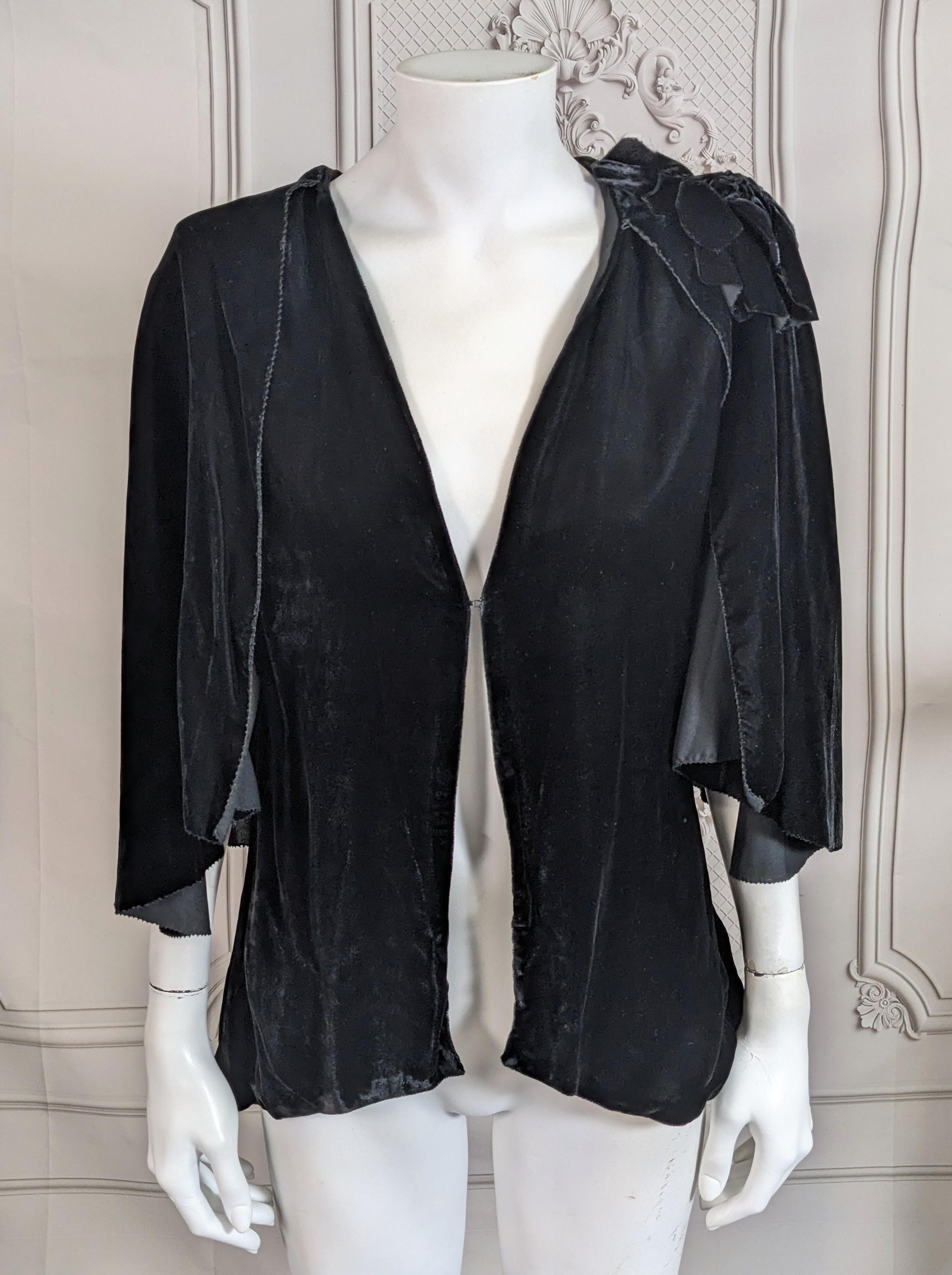 Art Deco Silk Velvet Capelet from the 1930's. Cut as a capelet jacket which is sleeveless underneath. One hook closure in front, but more can be added. Self fabric silk velvet flower on shoulder. 
1930's. Small size.