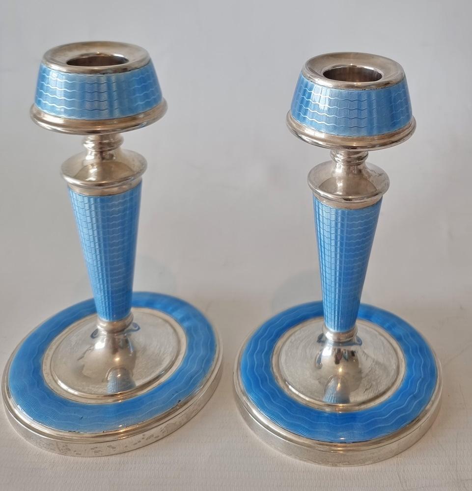 A superb pair of Art Deco silver and blue guilloche enamel candlesticks. The superb engine turned design, highlighted by the blue enamel. A very chic and stylish pair, with silver hallmarks for Birmingham, sterling,  date mark 1932, and makers mark. 