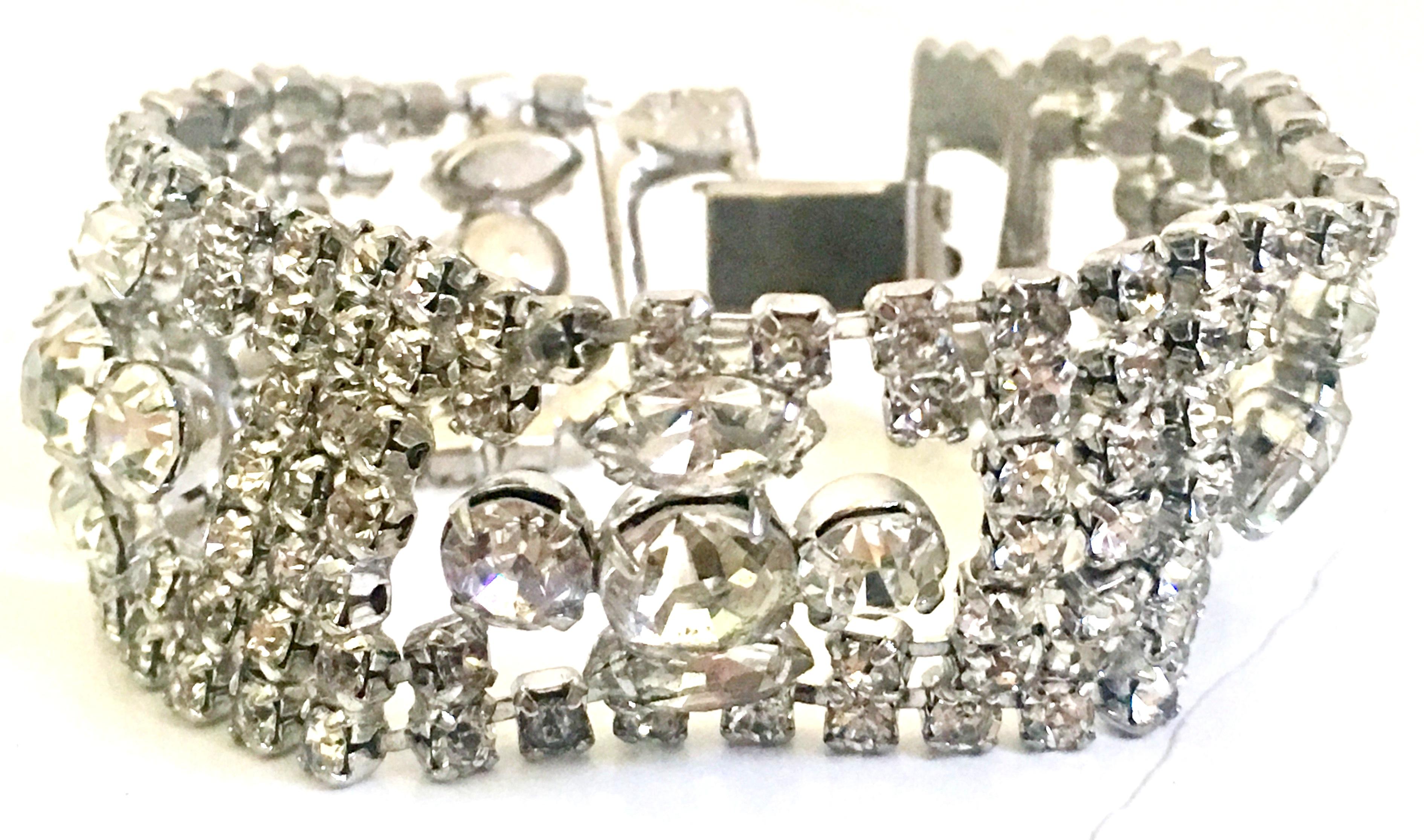 Art Deco Silver Pot Metal & Prong Set Austrian Crystal Clear Rhinestone Link Bracelet. This exquisite and geometric open link bracelet features a fold over box clasp.
