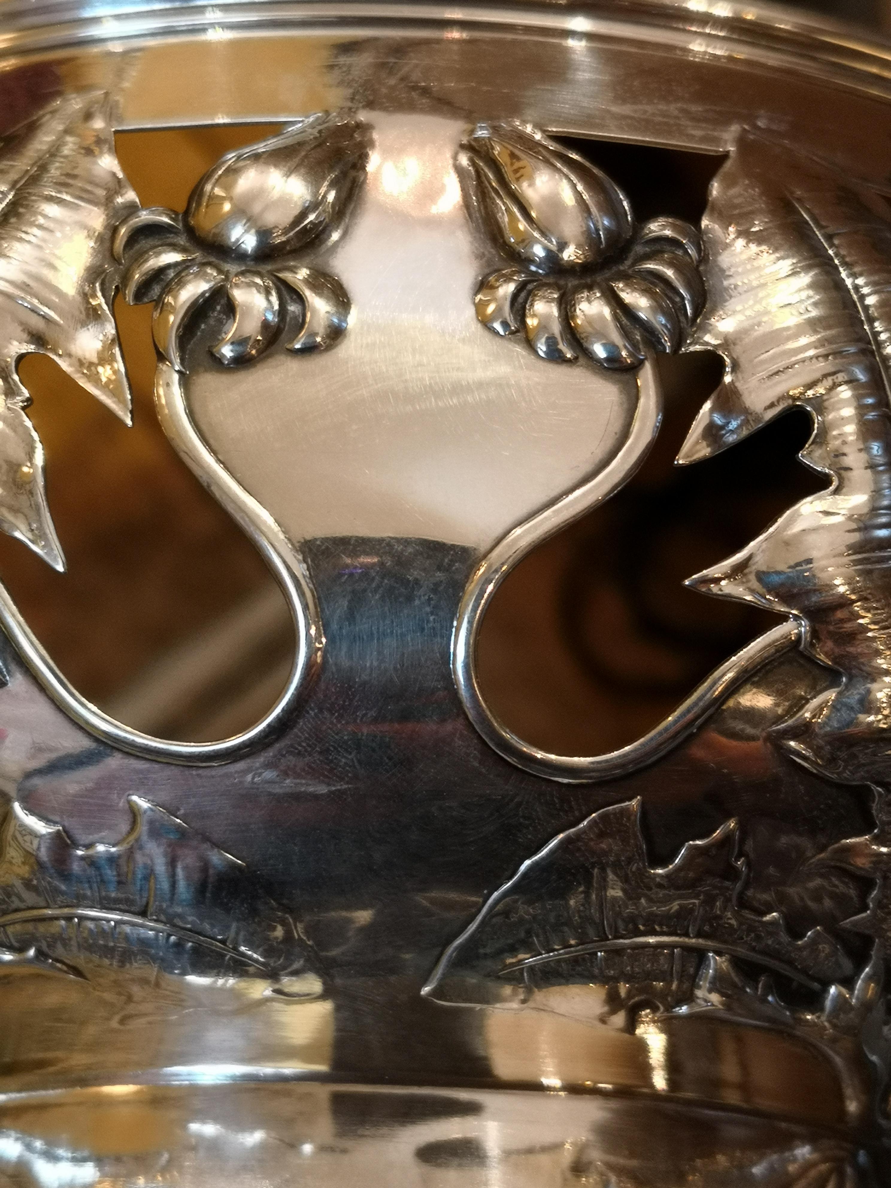 Large Art Deco silver bowl in 830 silver with a naturalistic formed garland of dandelion blossoms and leaves. Stamped with the Danish hallmarks and the Danish crowne. Backside stamped 830 silver and S&M Benzen for Sophie and Mathilde Benzen. Model