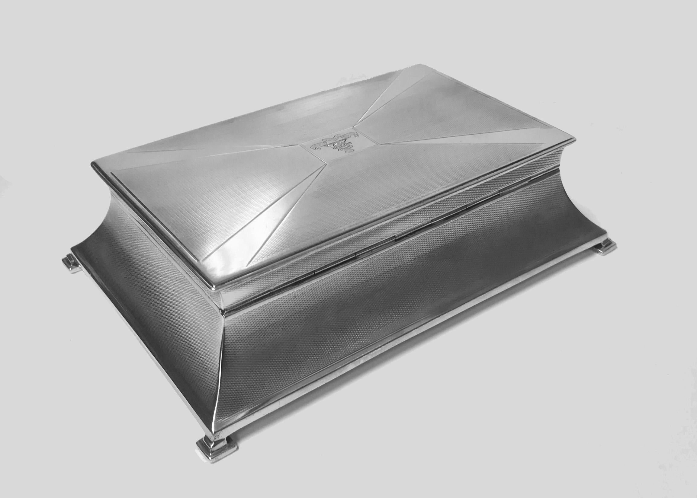 Large Art Deco Silver Box, Birmingham 1930 William Hutton & Sons. The unusual shape striking box on four bracket supports, the inverted tapered sides and cover with engine turned and polished silver ray design centering a cartouche engraved with the