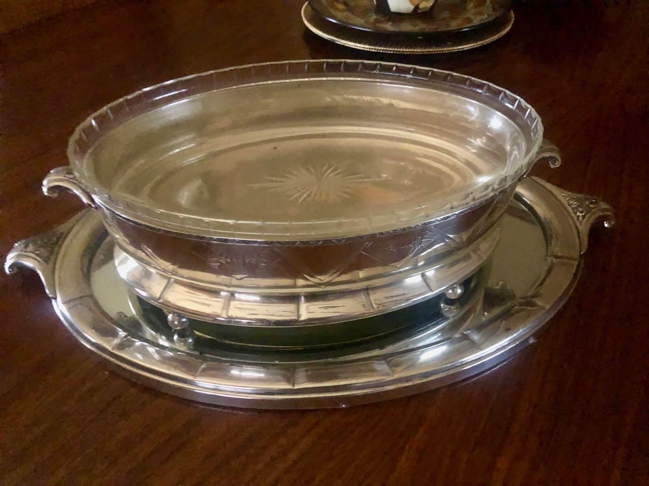 This Art Deco silver centerpiece has wonderful zig zag designs, a fluted glass insert with a starburst pattern and unique handles on the bowl and tray with geometric floral embellishments.

We have fallen in love with these early 20th century