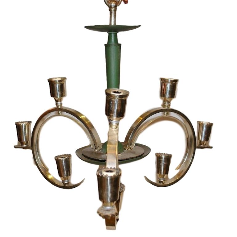 A circa 1930's Italian Art Deco chandelier with a light green painted finish and with three curving silvered arms that hold three lights each.

Measurements:
Diameter: 24