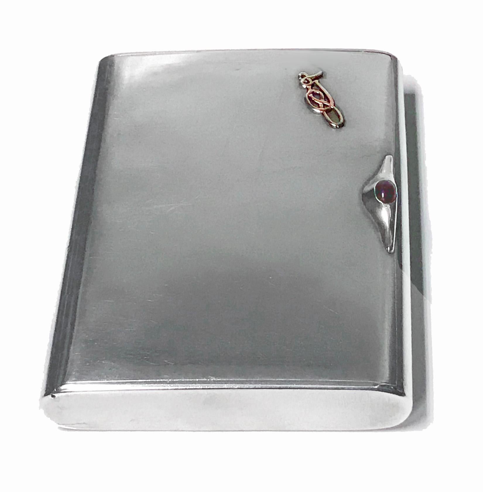 Art Deco Silver Cigarette Case Box, Estonia C.1925. Plain, flush hinge, cabochon red garnet thumb piece,gilded interior. No monograms, gold (tested) intertwined nouveau celtic insignia applied at one cornice, original patina, extremely light wear,