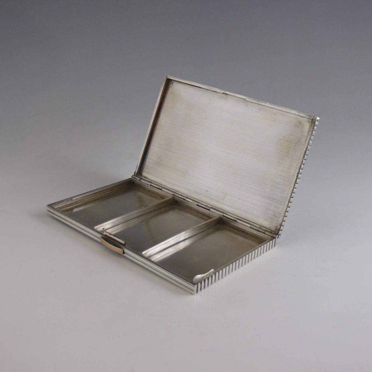 A stylish Art Deco fluted continental silver cigarette case with gold push button catch, circa 1920.

Dimensions: 13 cm/5 inches (length) x 8 cm/3 inches (width) x 0.5 cm/¼ inches (height)

Bentleys are Members of LAPADA, the London and Provincial
