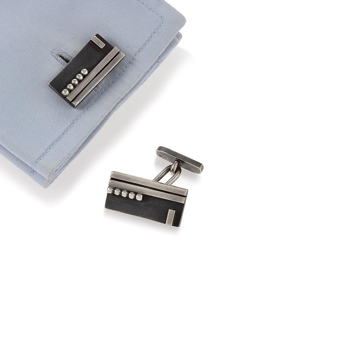 A pair of French Art Deco silver cuff links with by Jean Despres.  Circa 1930's.

Signed, J Despres and makers mark French mark for silver. 