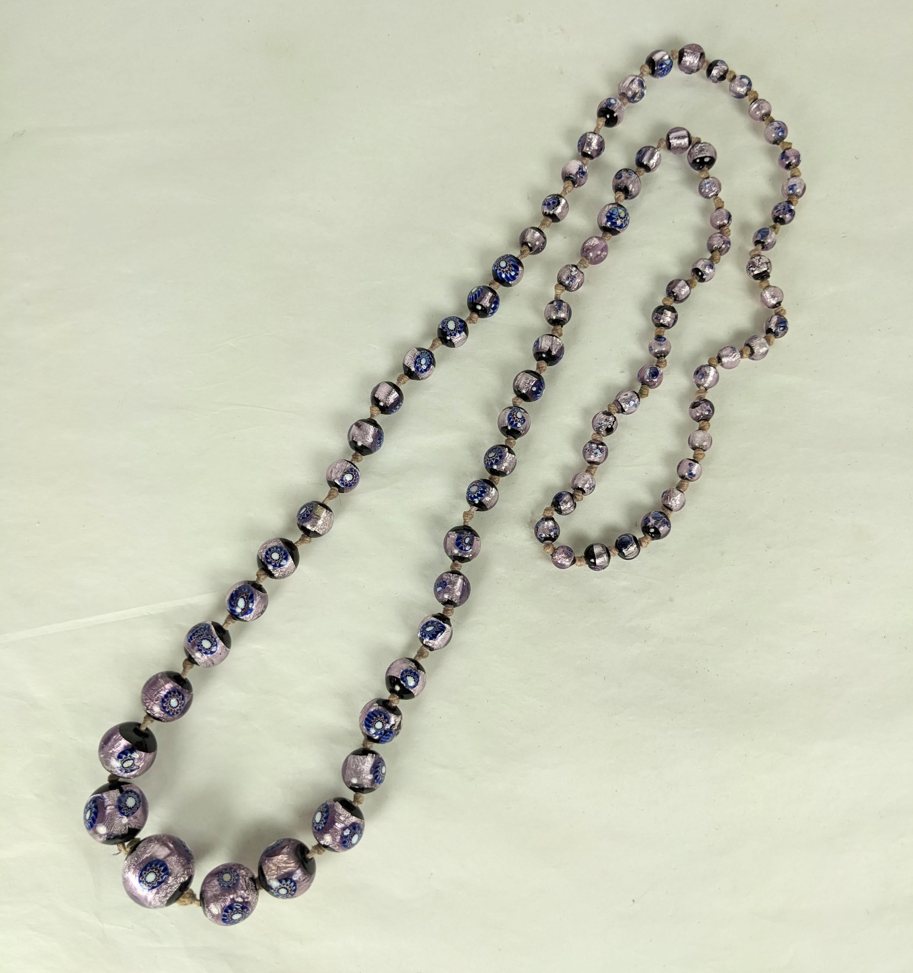 Art Deco Silver Foiled Murano Beads from the 1930's. Graduated and handmade with silvered foil within purple glass and floral murrine. Handmade and hand knotted, lovely quality. 32