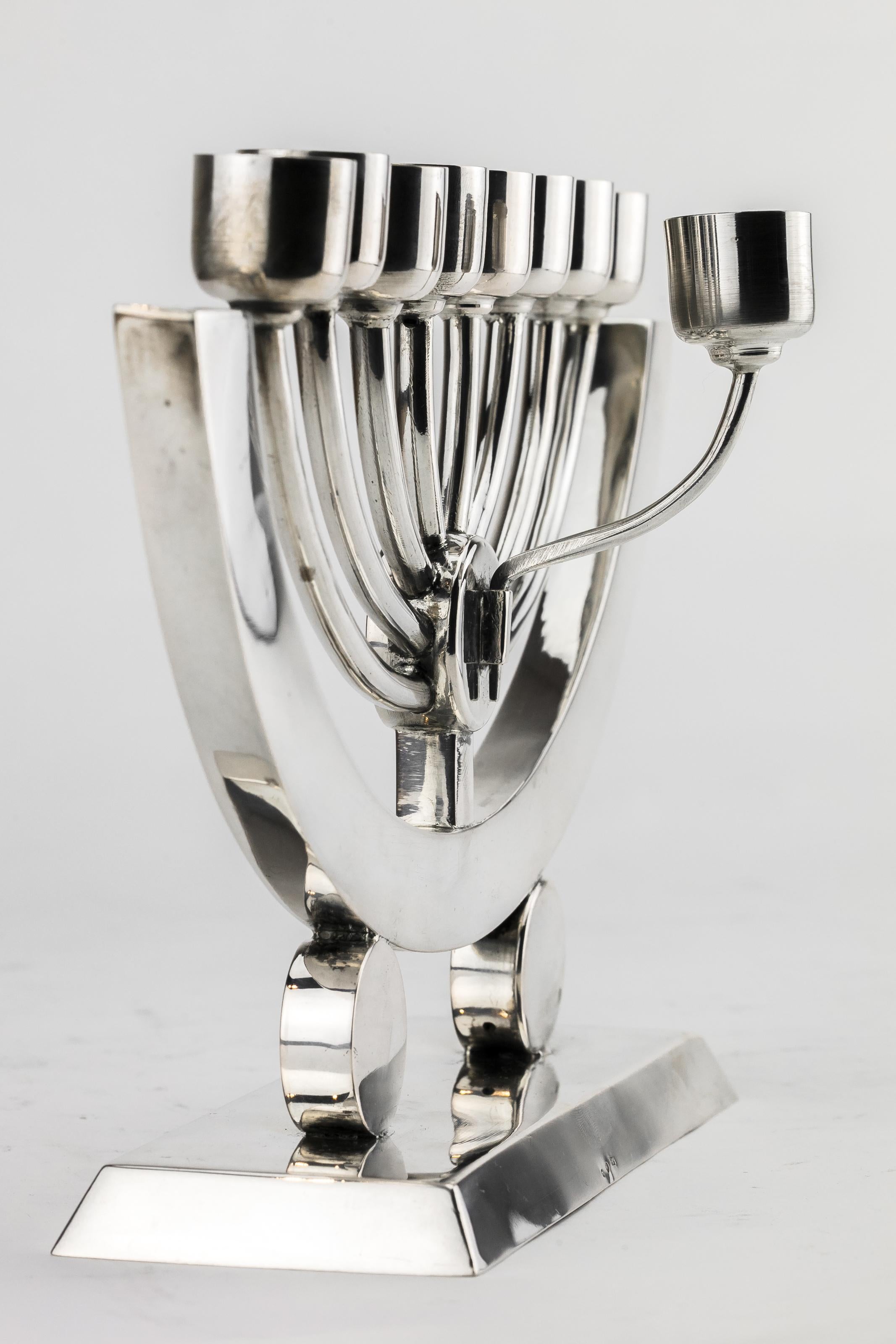 Handmade Art Deco silver Hanukkah Lamp Menorah, Krakow, Poland, circa 1920.
On rectangular base with two sphere supports that connect to a C-shaped main body. With eight oil receptacles and original servant lamp. Marked with maker's mark for JB and