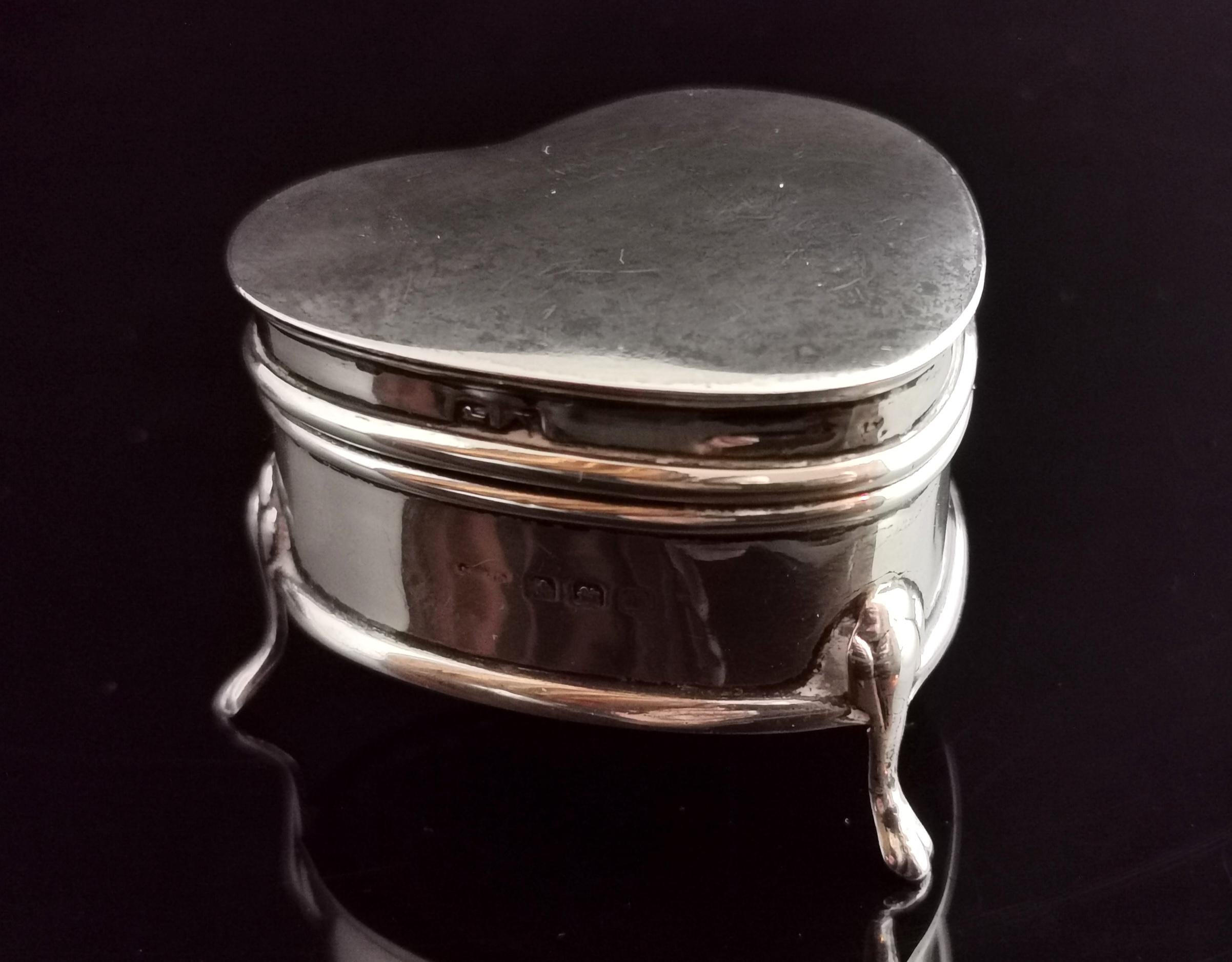 A beautiful Art Deco heart shaped sterling silver jewellery box.

It is a lovely piece perfect for showcasing a gift or storing your most precious pieces.

Made from solid sterling silver it stands raised on four paw feet and is shaped like a love