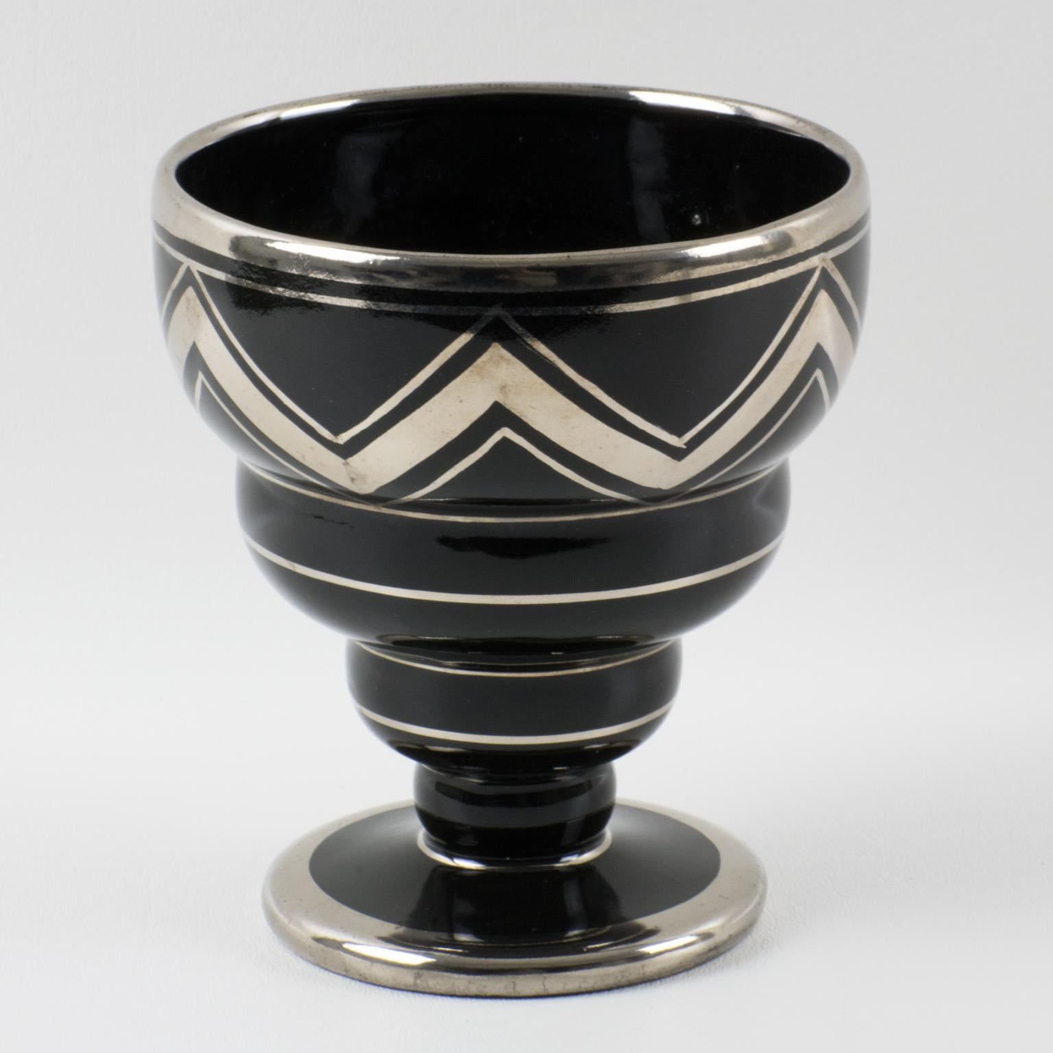 Ceram, Rouen, France, designed and crafted this stylish 1930s French Art Deco black ceramic vase. The decorative piece features silver deposit decoration with a geometric wave pattern. The original sticker label underside read 