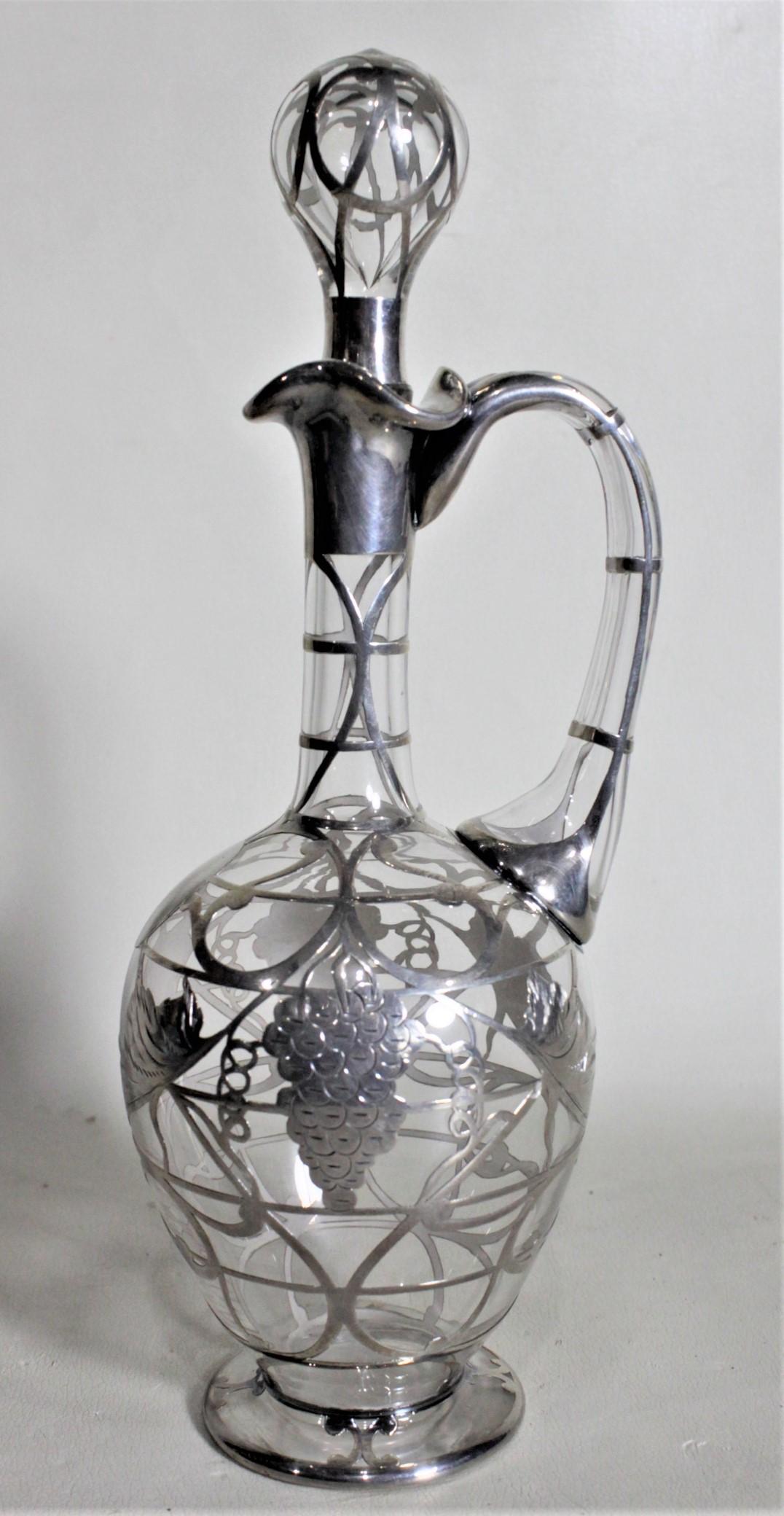 This hand formed and silver overlay decorated Sherry or Port decanter is unsigned, but presumed to have been made in Europe, likely Italy, in approximately 1920 in the period Art Deco style. The decanter is done with clear glass with a thick silver