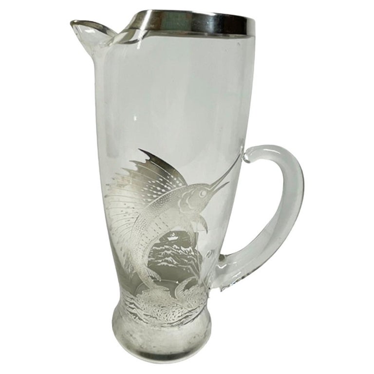 https://a.1stdibscdn.com/art-deco-silver-overlay-sailfish-pitcher-and-eight-tumblers-by-rockwell-silver-for-sale/f_73712/f_360153921693849672898/f_36015392_1693849673204_bg_processed.jpg?width=768
