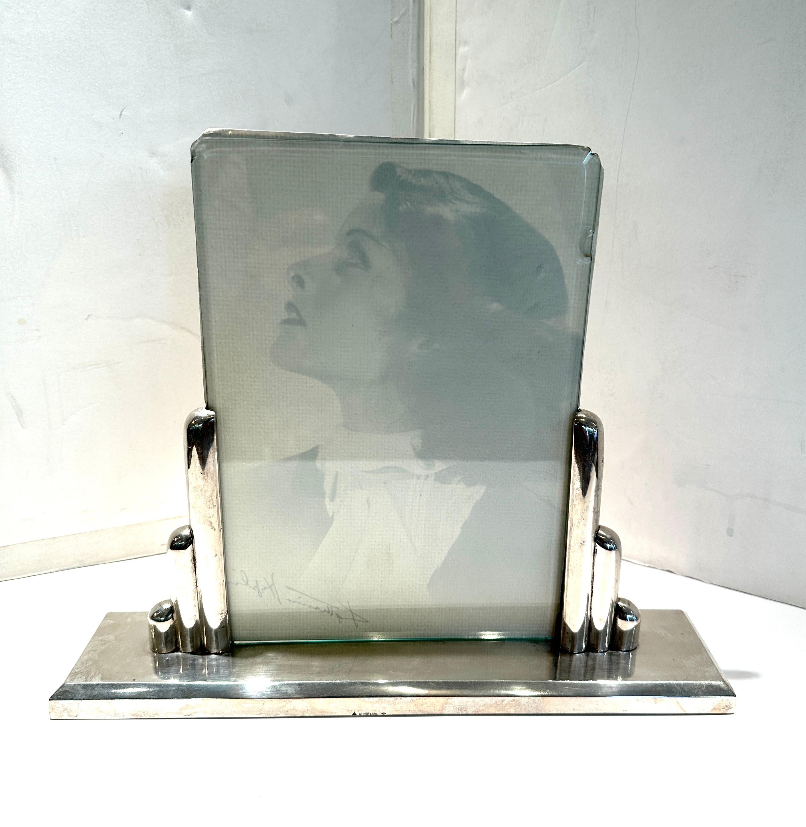 Classic Art Deco photo frame.  Continental 800 Silver, designed and made in Austria by Antole Buchruch.  Photo slips in between two bevel glasses, slips into the silver slots.
