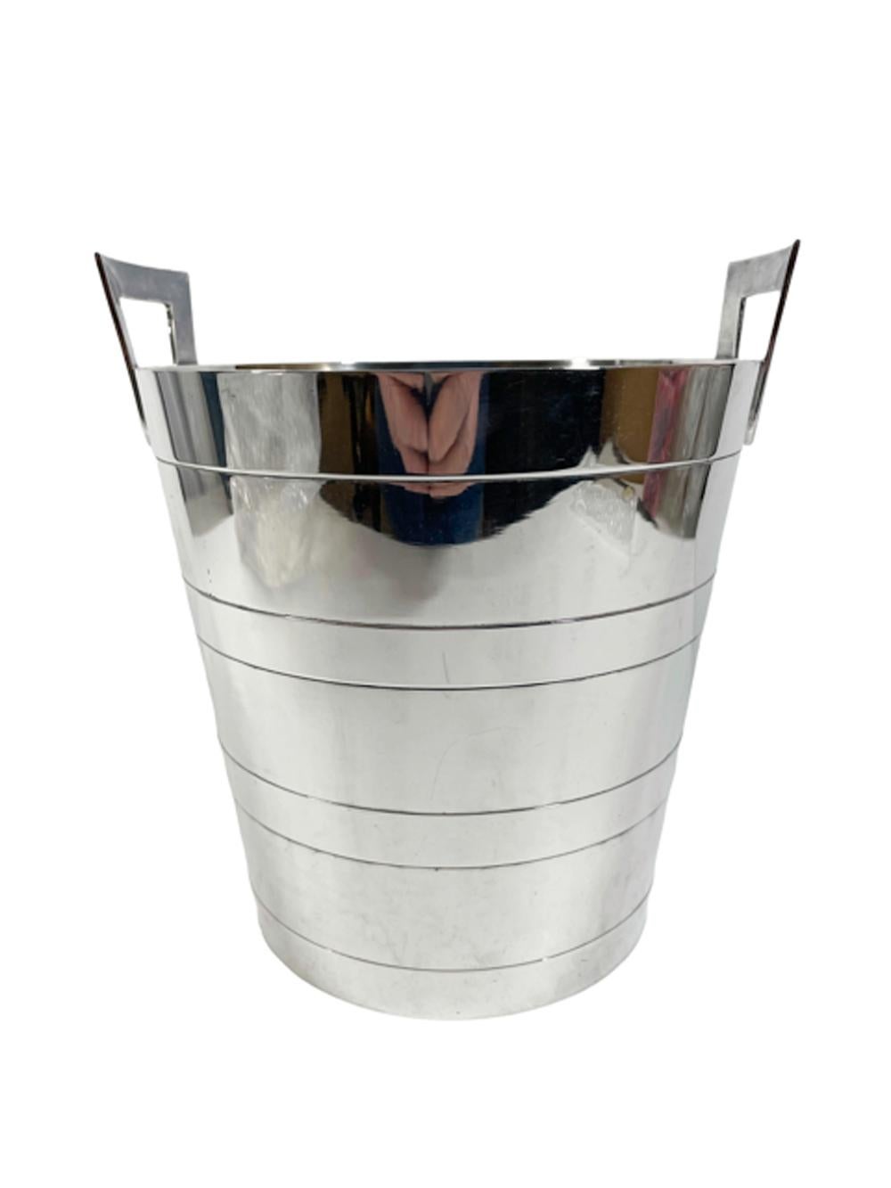 Art Deco silver plate champagne bucket / wine cooler of tapered form with incised bands and squared fixed handles, the interior with a pierced strainer set above the base to raise the ice above the water.