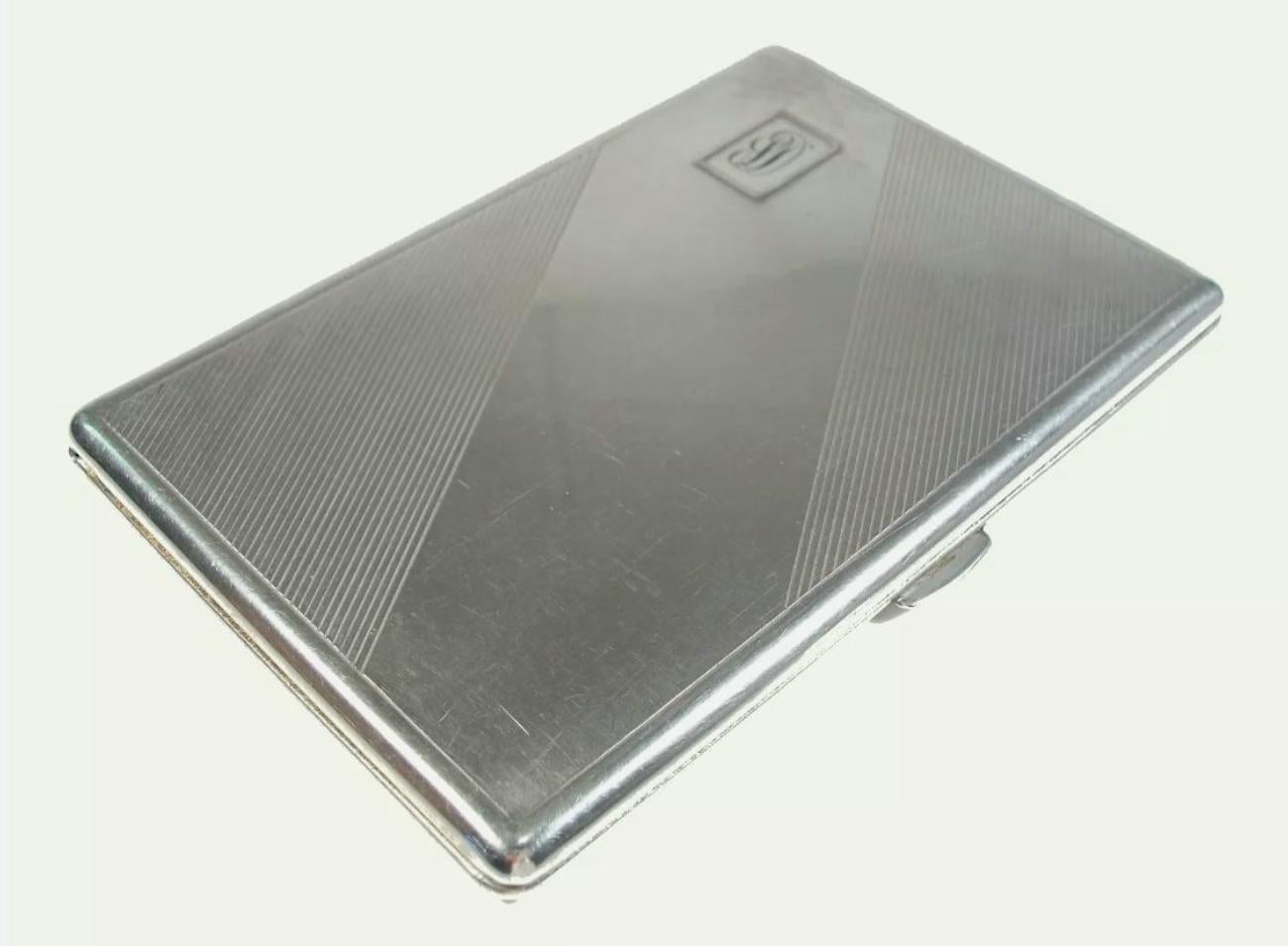 Art Deco period silver-plate cigarette case - 'D' monogram - delicate diagonal tooling - interior gilt wash - unsigned - United States (likely) - circa 1930's.

Excellent vintage condition - fine surface scratches from age and use - missing interior