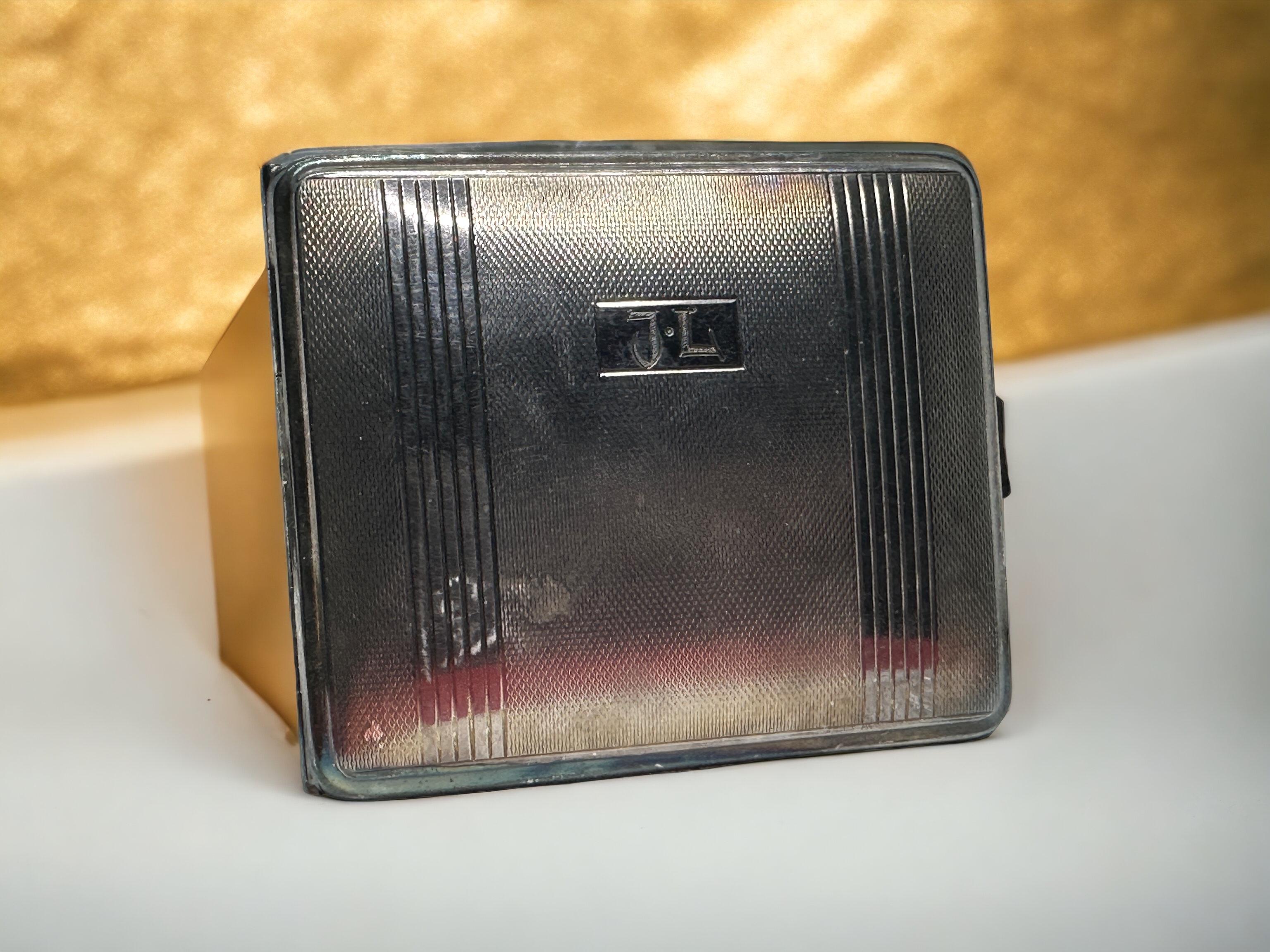 Beautiful Art Deco cigarette case by a German manufacturer. Silver plated alpaca. no makers mark, year 1930s. With J.L. monogram. Some minor dings and scratches commensurate with age and wear. Nice to use it and travel with it.