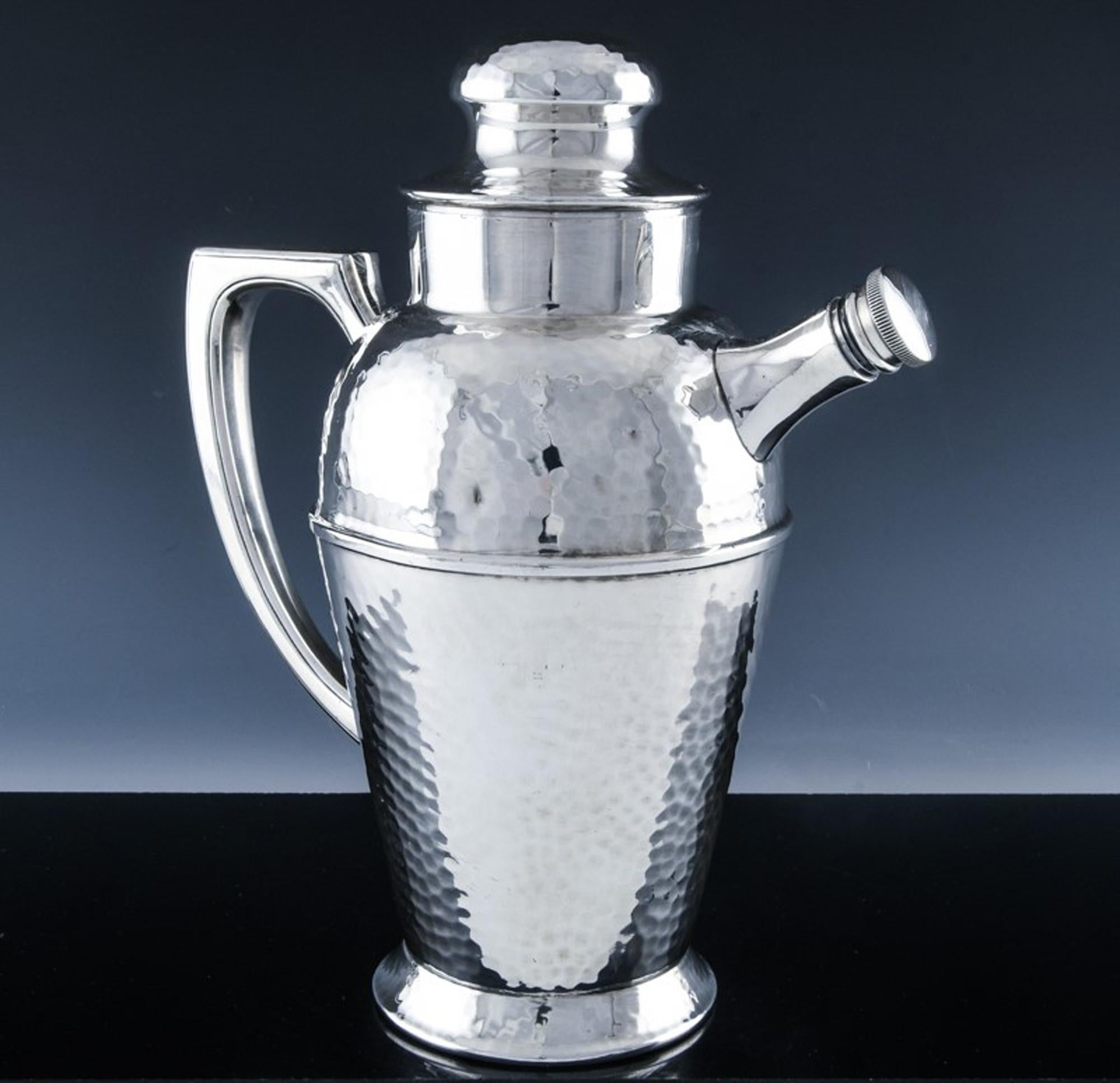 Art Deco silver plate cocktail and Martine shaker and pitcher,
1940

This cocktail shaker is a very fine quality silver plate example. The body is hammered and has an Art Deco form. The interior has a wide perforated lip so one can make your