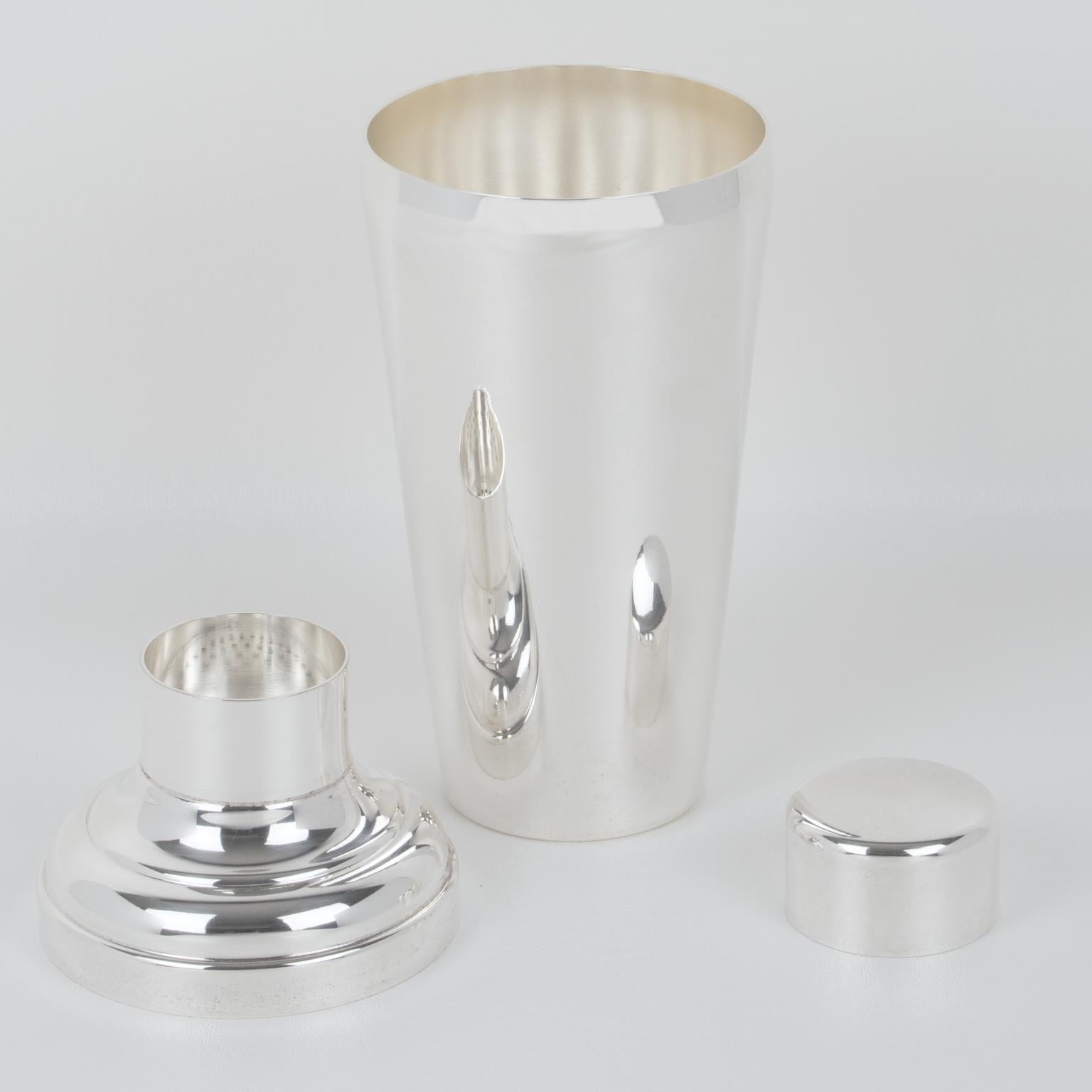 Silversmith Gelb, Paris, designed this sophisticated French Art Deco silver plate cylindrical cocktail or Martini shaker. The three-sectioned cocktail shaker has a removable cap and strainer filter. The piece boasts a lovely geometric shape with a