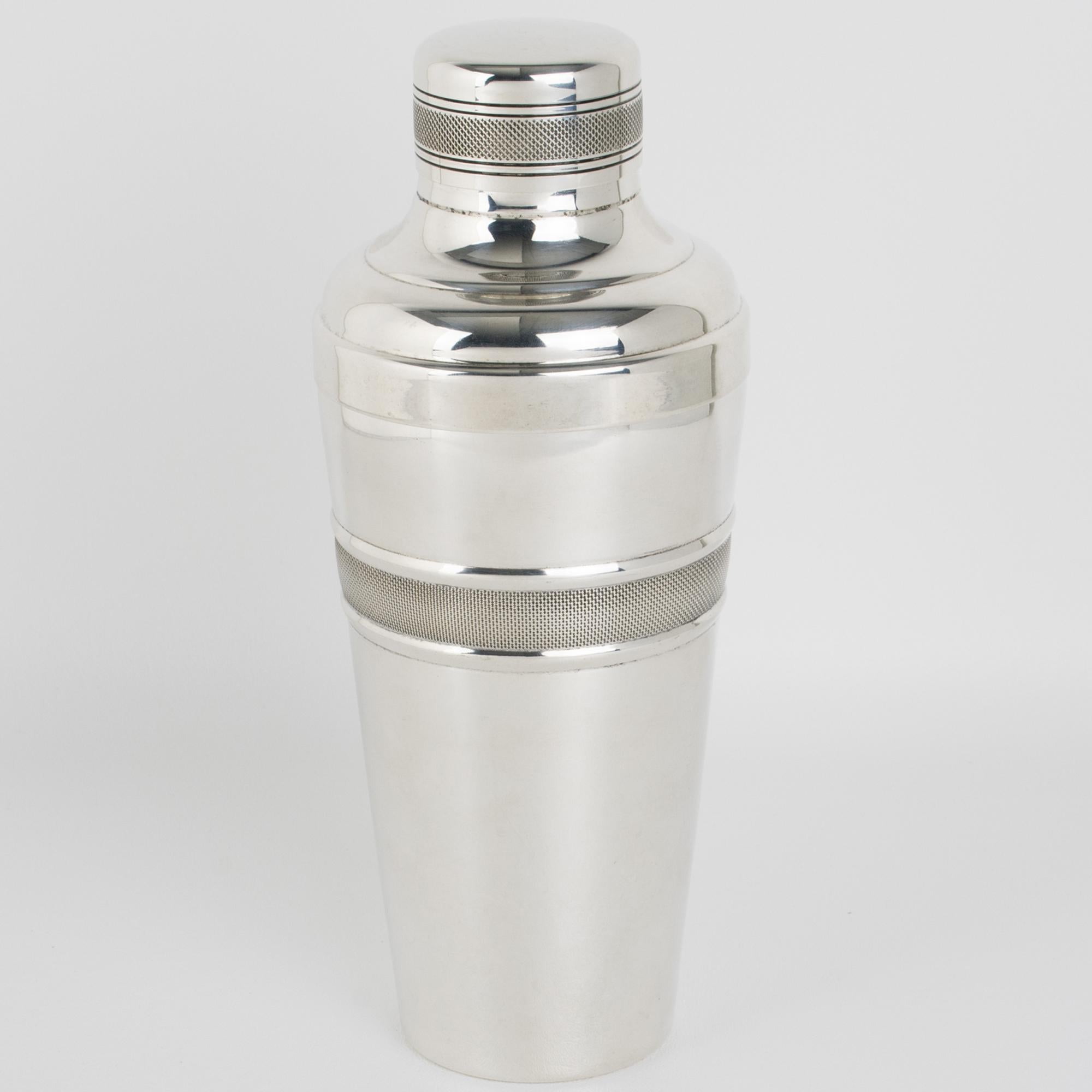 This lovely French Art Deco silver plate cylindrical cocktail or Martini shaker was crafted by silversmith Gelb, Paris, in the 1940s. The three-sectioned cocktail shaker has a removable cap and filter strainer. The piece boasts a lovely geometric