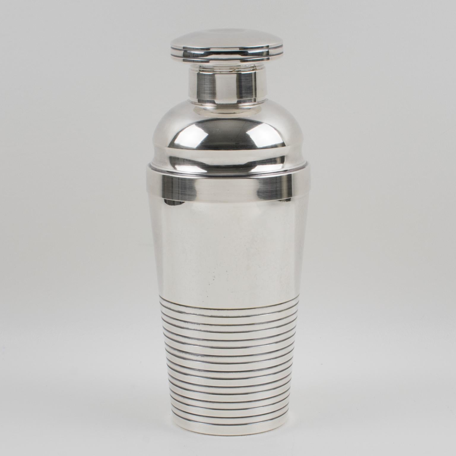 Stylish French Art Deco silver plate cylindrical cocktail or Martini shaker by silversmith Saint Medard, Paris. Three sectioned designed cocktail shaker with removable cap and strainer and lemon squeezer integrated underside of the strainer. Lovely