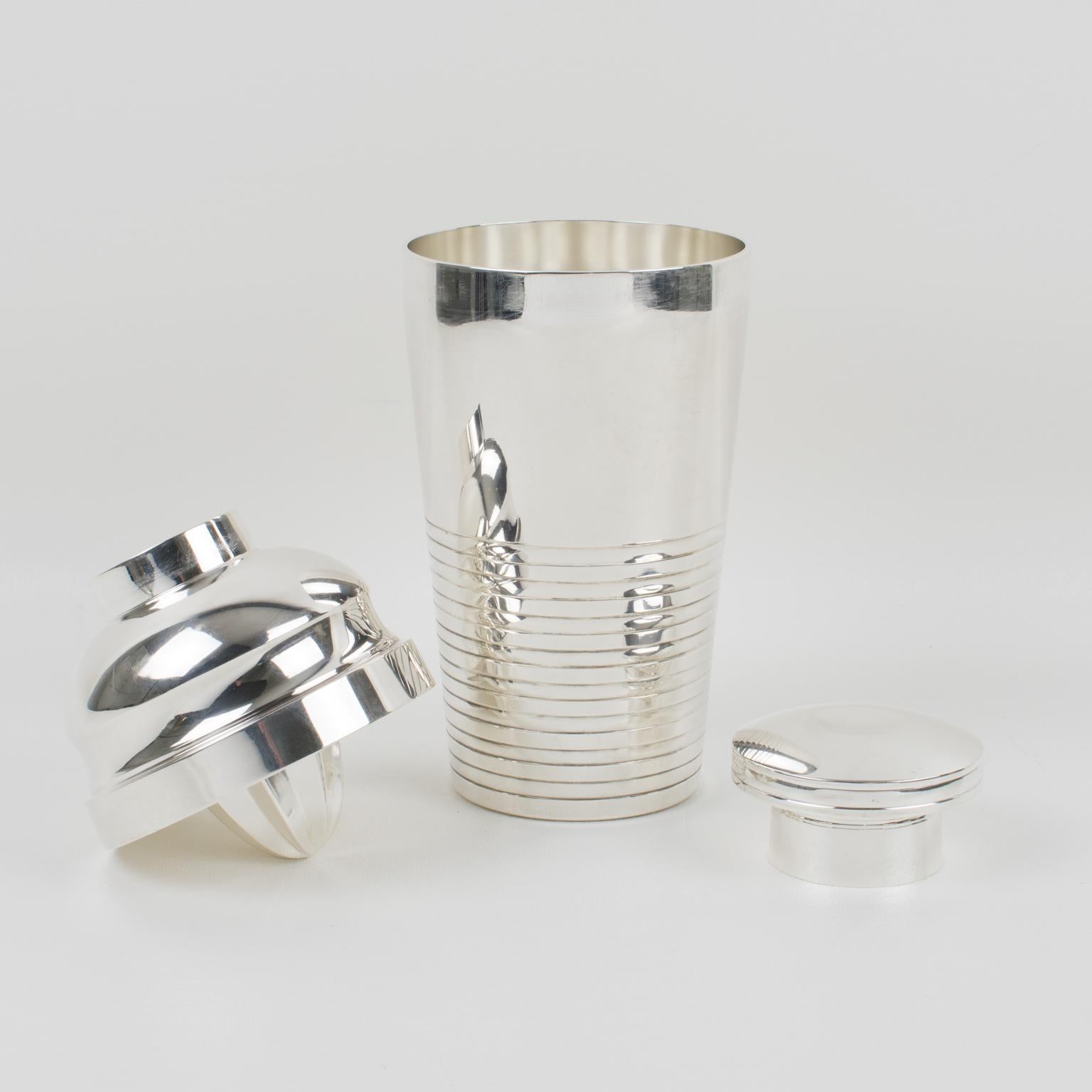 Stylish French Art Deco silver plate cylindrical cocktail or Martini shaker by silversmith Saint Medard, Paris. Three sectioned designed cocktail shaker with removable cap and strainer and lemon squeezer integrated underside of the strainer. Lovely