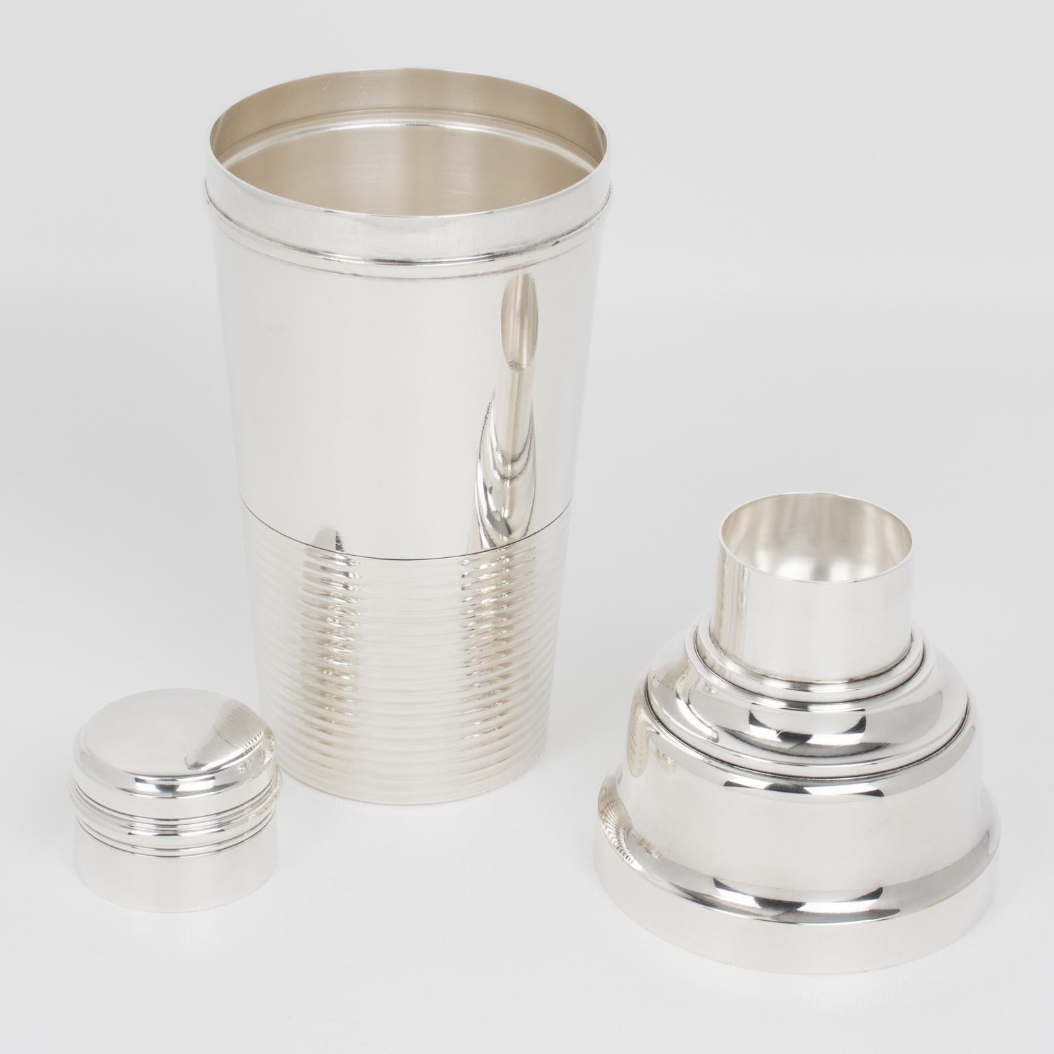 French silversmith Societe Parisienne d'Orfevrerie (SPO), Paris, crafted this lovely Art Deco silver plate cylindrical cocktail or Martini Shaker in the 1940s. The three-sectioned cocktail shaker has a removable cap and strainer. This accessory for